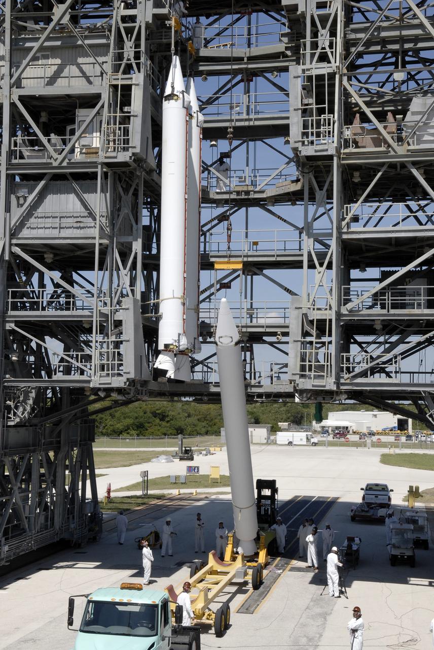 CAPE CANAVERAL, Fla. – On Launch Complex 17-B at Cape Canaveral Air Force Station, a third solid rocket booster is raised from the transporter. It will join the others in the mobile service tower for attachment to the Delta II rocket that will launch the STSS Demonstrator spacecraft. The STSS Demonstrators is a midcourse tracking technology demonstrator and is part of an evolving ballistic missile defense system. STSS is capable of tracking objects after boost phase and provides trajectory information to other sensors. It will be launched by NASA for the Missile Defense Agency on July 29. Photo credit: NASA/Kim Shiflett