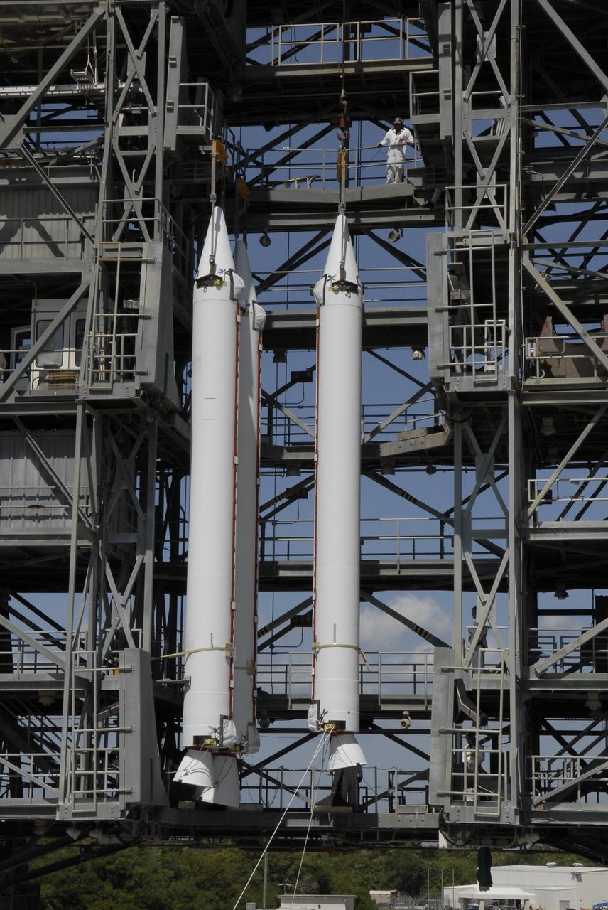 CAPE CANAVERAL, Fla. – On Launch Complex 17-B at Cape Canaveral Air Force Station, a third solid rocket booster is lifted into the mobile service tower next to the other two. The boosters will be attached to the Delta II rocket that will launch the STSS Demonstrator spacecraft. The STSS Demonstrators is a midcourse tracking technology demonstrator and is part of an evolving ballistic missile defense system. STSS is capable of tracking objects after boost phase and provides trajectory information to other sensors. It will be launched by NASA for the Missile Defense Agency on July 29. Photo credit: NASA/Kim Shiflett
