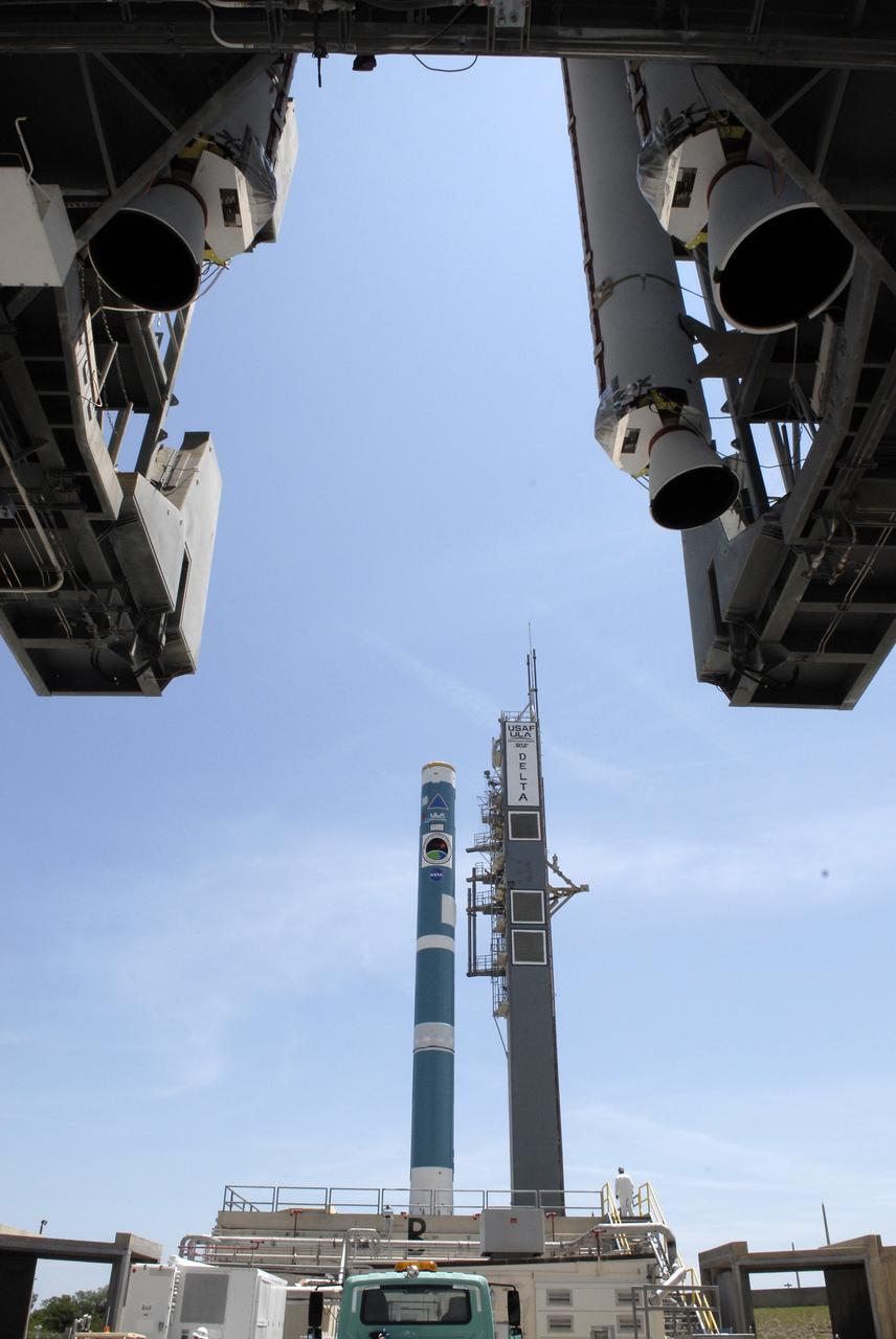 CAPE CANAVERAL, Fla. – On Launch Complex 17-B at Cape Canaveral Air Force Station, the first stage of the Delta II rocket in the background waits for the mobile service tower and the solid rocket boosters (top foreground) that will be attached. The Delta II is the launch vehicle for the STSS Demonstrator spacecraft. The STSS Demonstrators is a midcourse tracking technology demonstrator and is part of an evolving ballistic missile defense system. STSS is capable of tracking objects after boost phase and provides trajectory information to other sensors. It will be launched by NASA for the Missile Defense Agency on July 29. Photo credit: NASA/Kim Shiflett