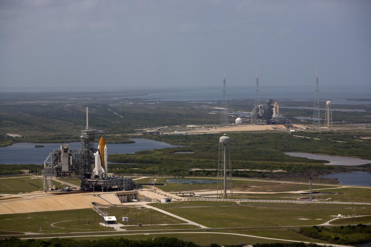 CAPE CANAVERAL, Fla. – After space shuttle Endeavour's rollout to Launch pad 39B at NASA's Kennedy Space Center in Florida this morning, two different shuttles are poised on two different launch pads. Shuttle Atlantis (left) already was on Launch Pad 39A. With the space shuttle fleet set for retirement in 2010, this is expected to be the final time two shuttles will be on launch pads at the same time. Endeavour will stand by at pad B in the unlikely event that a rescue mission is necessary during Atlantis' upcoming mission to upgrade NASA's Hubble Space Telescope. Atlantis is targeted to launch May 12. After Endeavour is cleared from its duty as a rescue spacecraft, it will be moved to Launch Pad 39A for its STS-127 mission to the International Space Station. That flight is targeted for launch June 13. Photo credit: NASA/Dimitri Gerondidakis
