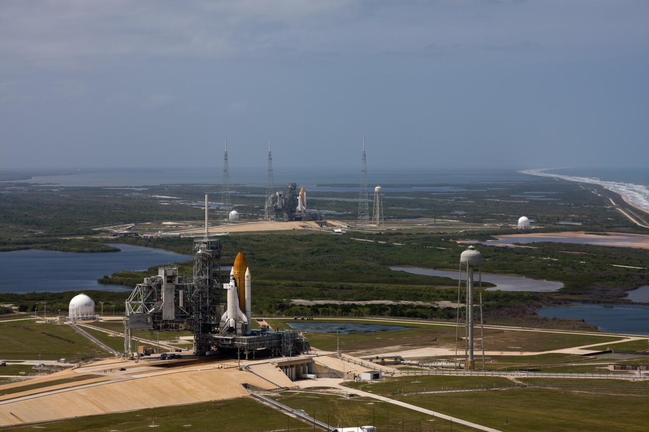 CAPE CANAVERAL, Fla. – After space shuttle Endeavour's rollout to Launch pad 39B at NASA's Kennedy Space Center in Florida this morning, two different shuttles are poised on two different launch pads. Shuttle Atlantis (foreground) already was on Launch Pad 39A. With the space shuttle fleet set for retirement in 2010, this is expected to be the final time two shuttles will be on launch pads at the same time. Endeavour will stand by at pad B in the unlikely event that a rescue mission is necessary during Atlantis' upcoming mission to upgrade NASA's Hubble Space Telescope. Atlantis is targeted to launch May 12. After Endeavour is cleared from its duty as a rescue spacecraft, it will be moved to Launch Pad 39A for its STS-127 mission to the International Space Station. That flight is targeted for launch June 13. Photo credit: NASA/Dimitri Gerondidakis