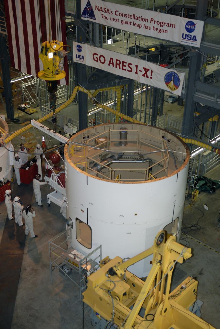 CAPE CANAVERAL, Fla. – In high bay 4 of the Vehicle Assembly Building at NASA's Kennedy Space Center in Florida, at left center, technicians get ready to install the roll control system in the Ares I-X segment in the center.  Ares I-X is the test vehicle for the Ares I, which is part of the Constellation Program to return men to the moon and beyond. Ares I-X is targeted for launch in July 2009.  Photo credit: NASA/Kim Shiflett