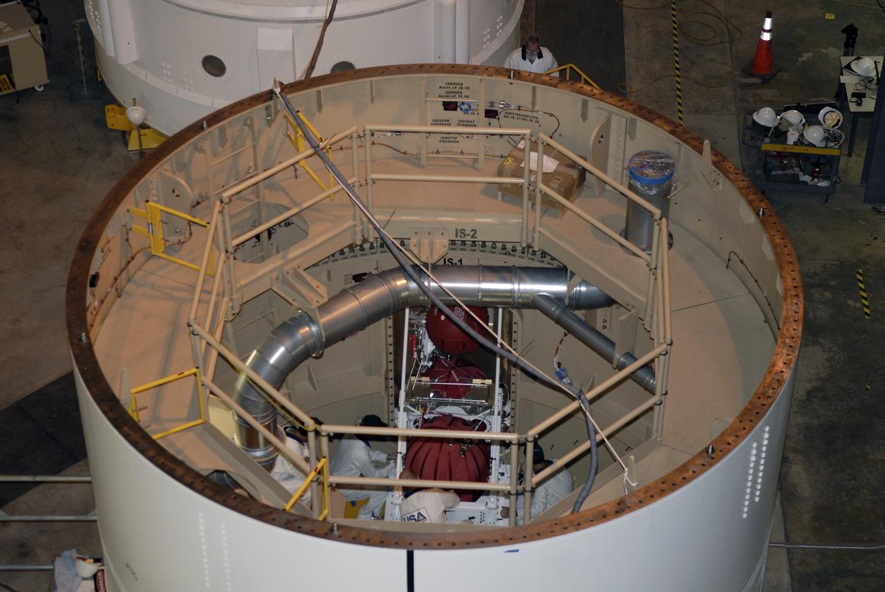 CAPE CANAVERAL, Fla. –– In high bay 4 of the Vehicle Assembly Building at NASA's Kennedy Space Center in Florida, technicians are seen inside the Ares I-X segment installing the roll control system. Ares I-X is the test vehicle for the Ares I, which is part of the Constellation Program to return men to the moon and beyond. Ares I-X is targeted for launch in July 2009.  Photo credit: NASA/Kim Shiflett