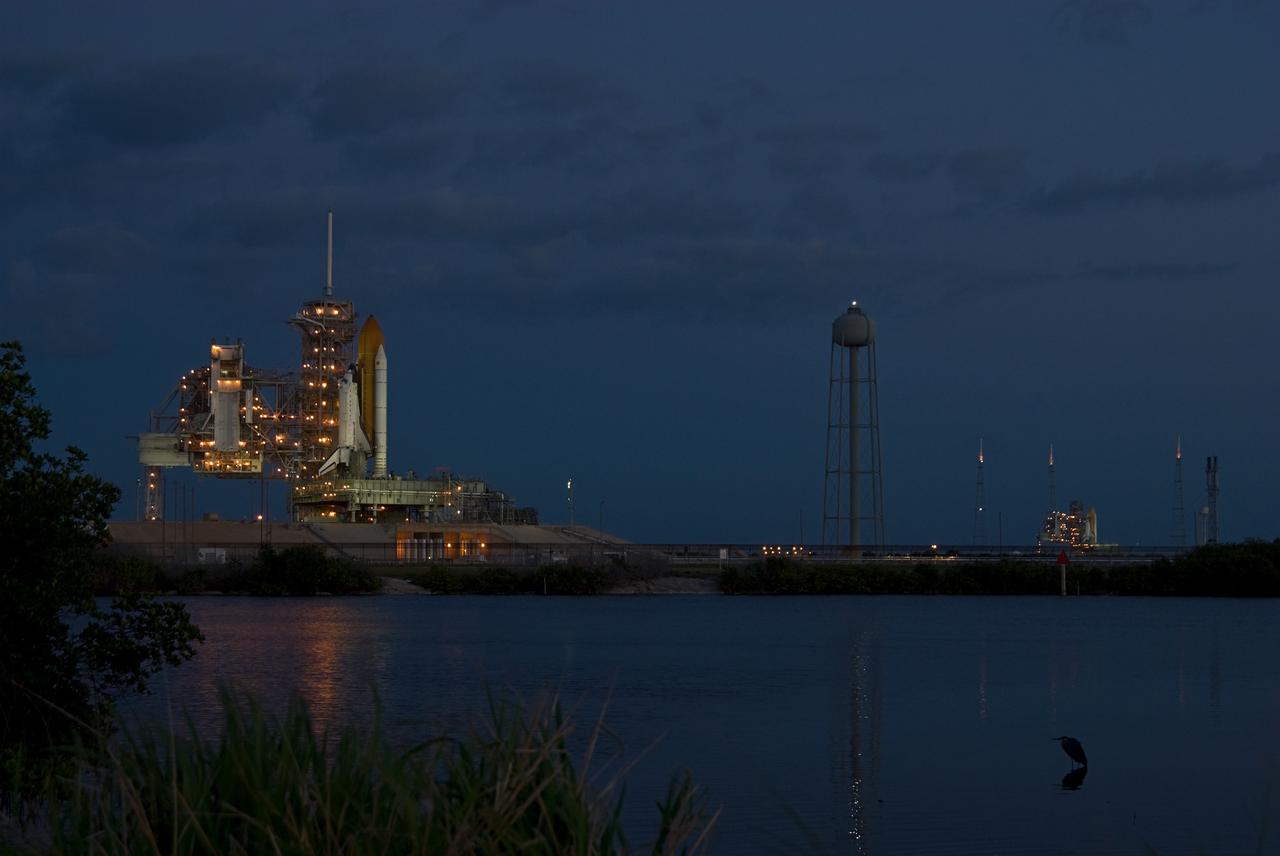 CAPE CANAVERAL, Fla. –– Launch Pads 39A and 39B at NASA's Kennedy Space Center in Florida are ablaze with lights before dawn, showing shuttles on both pads. At left is space shuttle Atlantis, poised for the STS-125 mission targeted to launch May 12, and at right is space shuttle Endeavour. Endeavour will be prepared on the pad for liftoff in the unlikely event that a rescue mission is necessary following Atlantis' launch. After Atlantis is cleared to land, Endeavour will move to Launch Pad 39A for its upcoming STS-127 mission to the International Space Station, targeted to launch June 13. Photo credit: NASA/Chris Rhodes