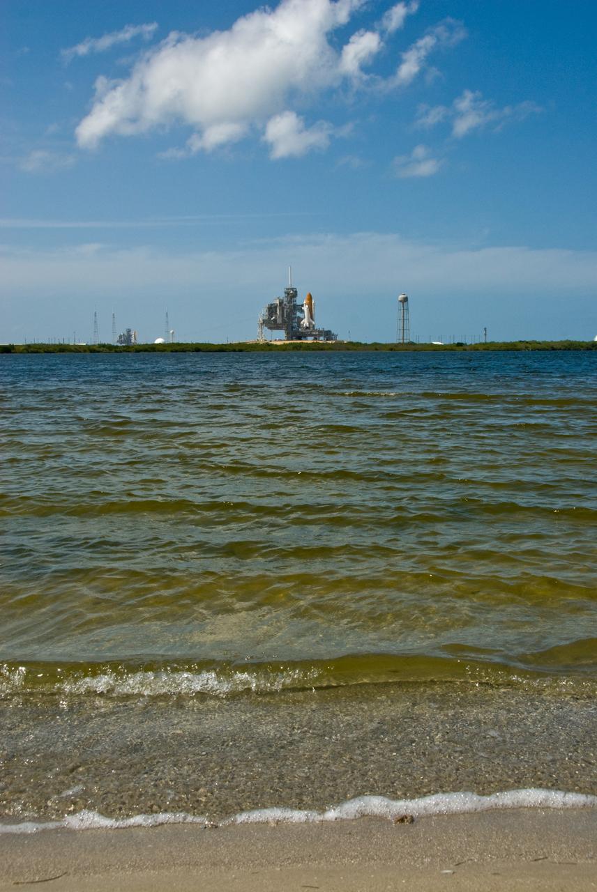 CAPE CANAVERAL, Fla. –– Viewed across the lagoon at NASA's Kennedy Space Center in Florida, space shuttles Atlantis (right) and Endeavour (background left) are seen on Launch Pad 39A and 39B respectively. With the space shuttle fleet set for retirement in 2010, this is expected to be the final time two shuttles will be on launch pads at the same time.  Endeavour will stand by at pad B in the unlikely event that a rescue mission is necessary during Atlantis' upcoming mission to upgrade NASA's Hubble Space Telescope. Atlantis is targeted to launch May 12. After Endeavour is cleared from its duty as a rescue spacecraft, it will be moved to Launch Pad 39A for its STS-127 mission to the International Space Station. That flight is targeted for launch June 13.   Photo credit:  NASA/Kim Shiflett
