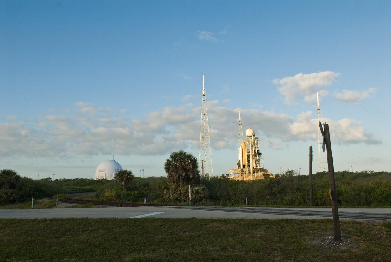 CAPE CANAVERAL, Fla. –– Sunlight spotlights space shuttle Endeavour poised on Launch Pad 39B at NASA's Kennedy Space Center in Florida. In the foreground is the railway that services Kennedy. Surrounding the pad are the lightning towers erected for NASA's Constellation Program, which will use the pad for Ares rocket launches. Endeavour will be prepared on the pad for liftoff in the unlikely event that a rescue mission is necessary following space shuttle Atlantis' launch May 12 on the STS-125 mission to upgrade NASA's Hubble Space Telescope. After Atlantis is cleared to land, Endeavour will move to Launch Pad 39A for its upcoming STS-127 mission to the International Space Station, targeted to launch June 13. Photo credit: NASA/Jack Pfaller