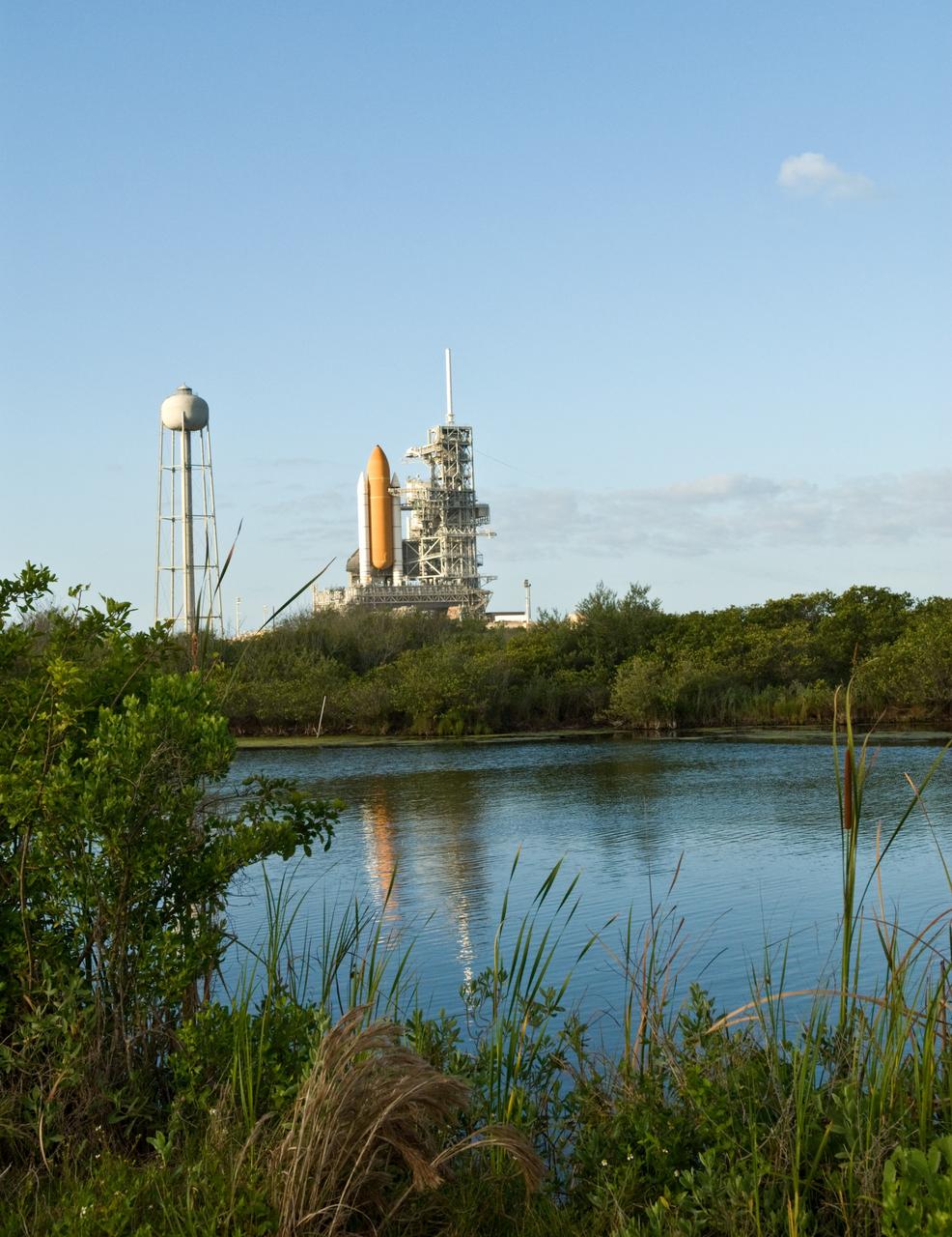 CAPE CANAVERAL, Fla. –– Space shuttle Atlantis on Launch Pad 39A is viewed across the lagoon at NASA's Kennedy Space Center in Florida. Atlantis is targeted to launch May 12 on the STS-125 mission to upgrade NASA's Hubble Space Telescope. Endeavour will be prepared on the pad for liftoff in the unlikely event that a rescue mission is necessary following space shuttle Atlantis' launch May 12 on the STS-125 mission to upgrade NASA's Hubble Space Telescope. After Atlantis is cleared to land, Endeavour will move to Launch Pad 39A for its upcoming STS-127 mission to the International Space Station, targeted to launch June 13. Photo credit: NASA/Jack Pfaller