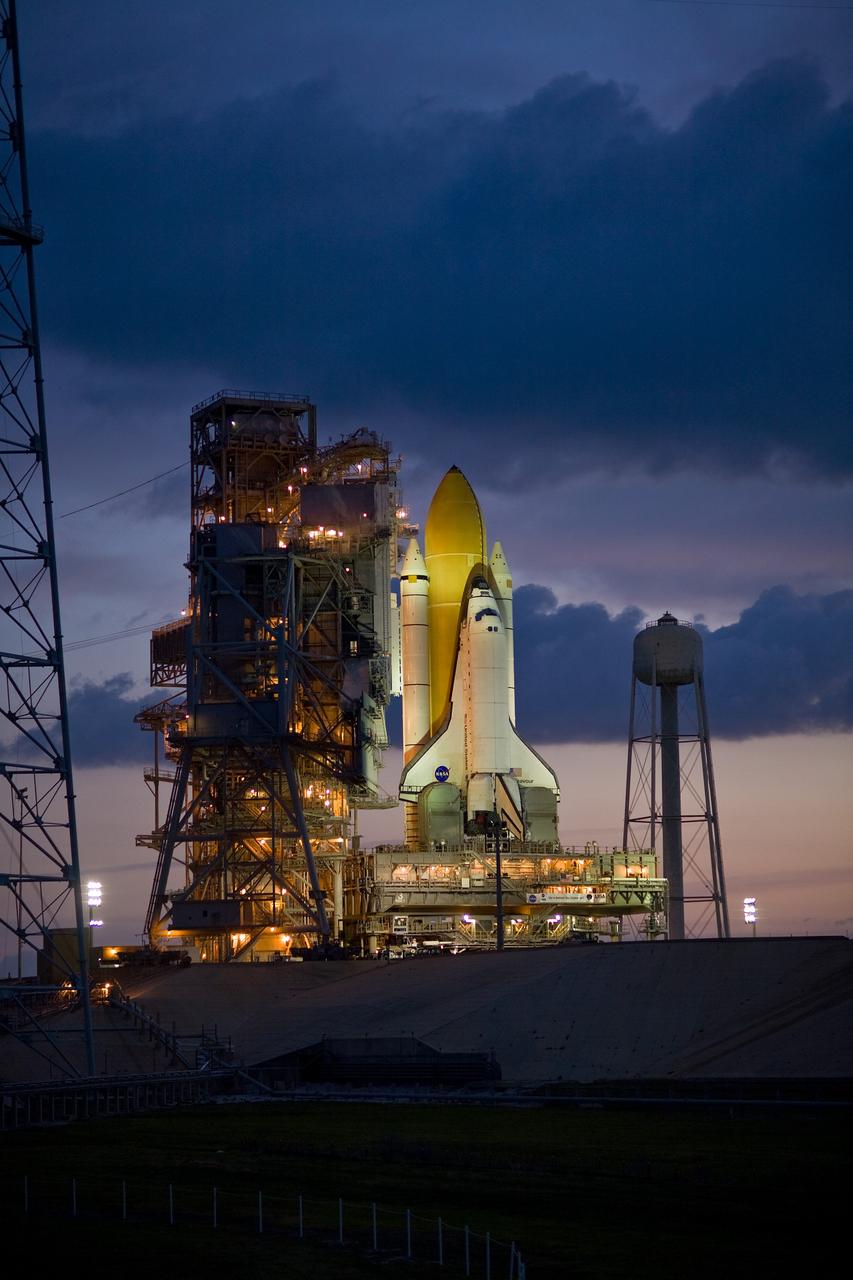 CAPE CANAVERAL, Fla. –– As dawn begins to brighten the sky over Launch Pad 39B at NASA's Kennedy Space Center in Florida, space shuttle Endeavour is seen bathed in lights from the fixed service structure. Endeavour  joins Atlantis, which is on Launch Pad 39A.  With the space shuttle fleet set for retirement in 2010, this is expected to be the final time two shuttles will be on launch pads at the same time.  Endeavour will be prepared on the pad for liftoff in the unlikely event that a rescue mission is necessary following space shuttle Atlantis' launch on the STS-125 mission to service NASA's  Hubble Space Telescope. After Atlantis is cleared to land, Endeavour will move to Launch Pad 39A for its upcoming STS-127 mission to the International Space Station, targeted to launch June 13.  Photo credit: NASA/Dimitri Gerondidakis