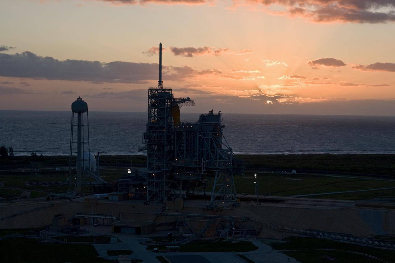 CAPE CANAVERAL, Fla. –– Dawn breaks over the Atlantic Ocean behind space shuttle Atlantis on Launch Pad 39A at NASA's Kennedy Space Center in Florida. Atlantis is targeted to launch May 12 on its STS-125 mission.  Space shuttle Endeavour sits on Launch Pad 39B, probably the final time two shuttles will be on launch pads at the same time with the space shuttle fleet set for retirement in 2010.  Endeavour will be prepared on the pad for liftoff in the unlikely event that a rescue mission is necessary following space shuttle Atlantis' launch on the STS-125 mission to service NASA's  Hubble Space Telescope. After Atlantis is cleared to land, Endeavour will move to Launch Pad 39A for its upcoming STS-127 mission to the International Space Station, targeted to launch June 13.  Photo credit: NASA/Dimitri Gerondidakis