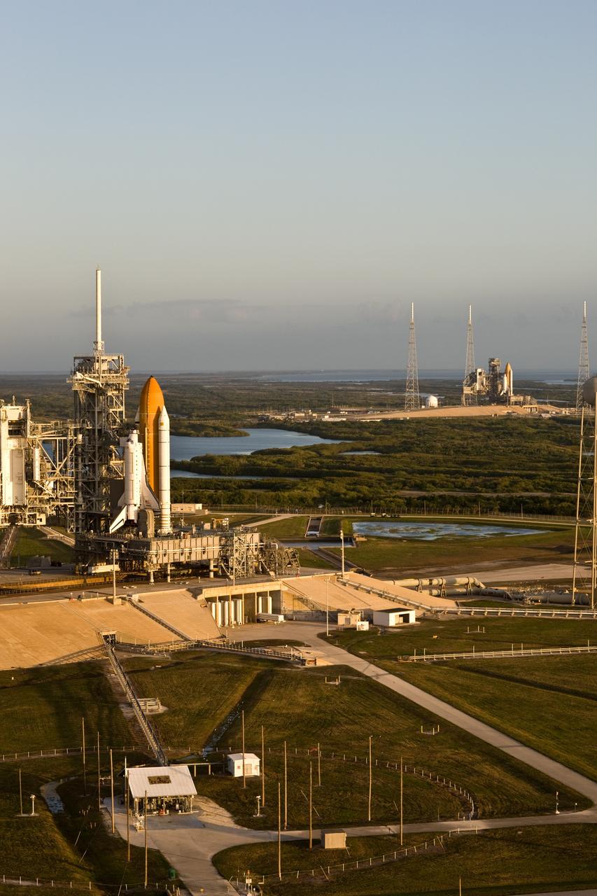 CAPE CANAVERAL, Fla. –– Sunlight spotlights space shuttle Atlantis (left) and space shuttle Endeavour on Launch Pads 39A and 39B, respectively, at NASA's Kennedy Space Center in Florida. This is probably the final time two shuttles will be on launch pads at the same time with the space shuttle fleet set for retirement in 2010. Endeavour will be prepared on the pad for liftoff in the unlikely event that a rescue mission is necessary following space shuttle Atlantis' launch on the STS-125 mission to service NASA's Hubble Space Telescope. After Atlantis is cleared to land, Endeavour will move to Launch Pad 39A for its upcoming STS-127 mission to the International Space Station, targeted to launch June 13. Photo credit: NASA/Dimitri Gerondidakis
