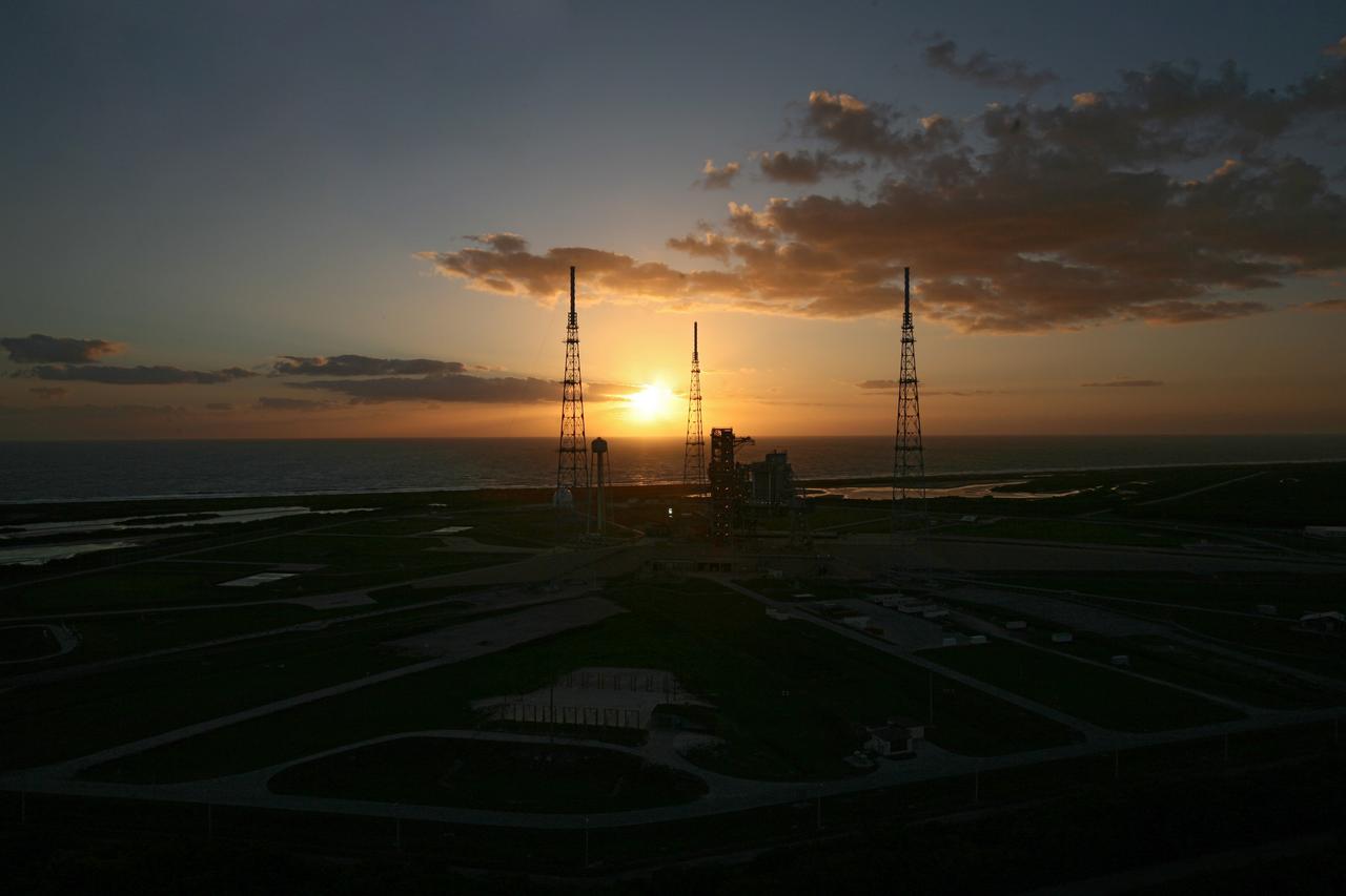 CAPE CANAVERAL, Fla. –– Dawn rises over the Atlantic Ocean behind space shuttle Endeavour on Launch Pad 39B at NASA's Kennedy Space Center in Florida.  Surrounding the pad are the lightning towers erected for NASA's Constellation Program, which will use the pad for Ares rocket launches. Endeavour has joined space shuttle Atlantis, which is on pad 39A. This is probably the final time two shuttles will be on launch pads at the same time with the space shuttle fleet set for retirement in 2010. Endeavour will be prepared on the pad for liftoff in the unlikely event that a rescue mission is necessary following space shuttle Atlantis' launch on the STS-125 mission to service NASA's  Hubble Space Telescope. After Atlantis is cleared to land, Endeavour will move to Launch Pad 39A for its upcoming STS-127 mission to the International Space Station, targeted to launch June 13.   Photo credit: NASA/Dimitri Gerondidakis