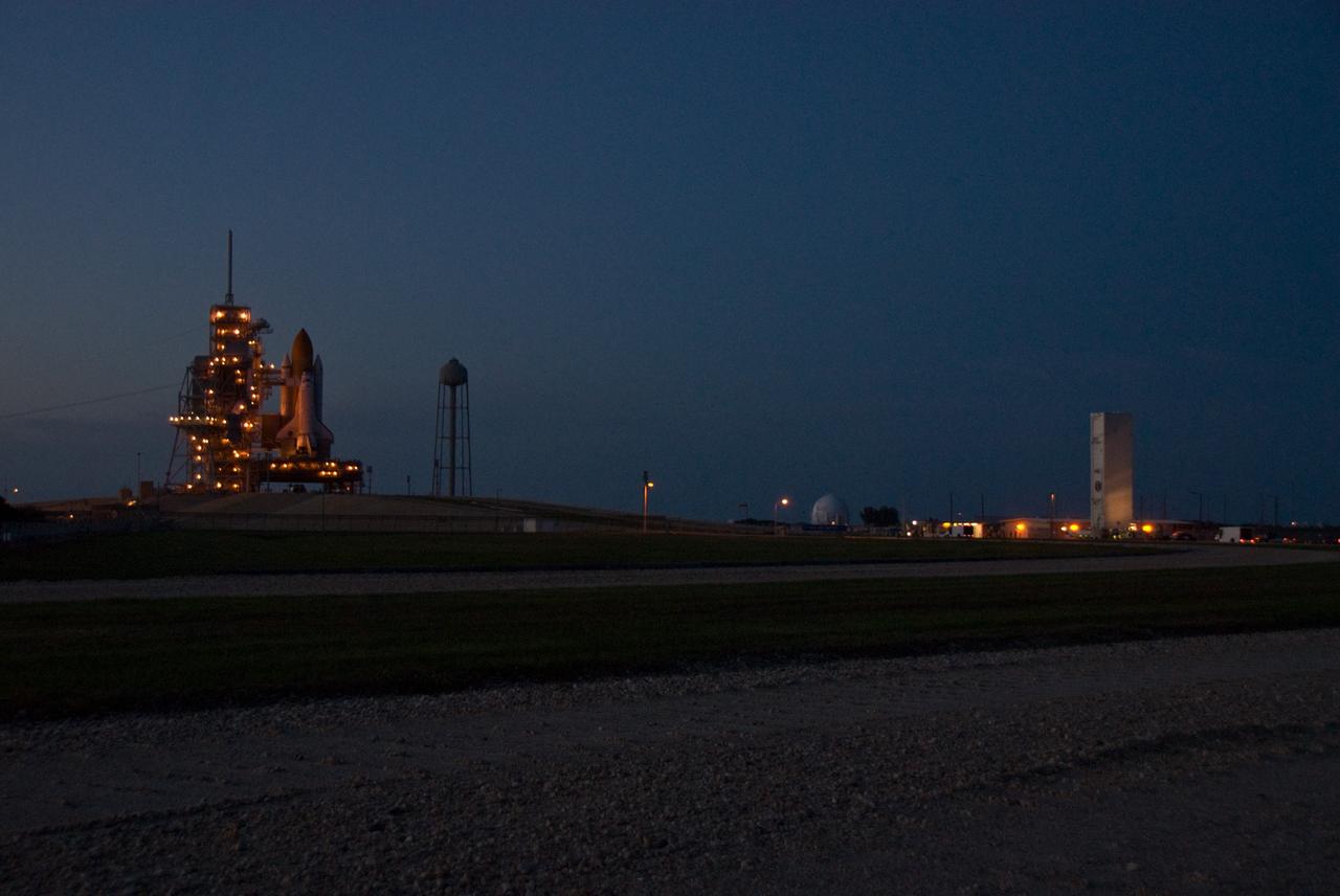 CAPE CANAVERAL, Fla. –– At NASA's Kennedy Space Center in Florida, the payload canister with the Hubble Space Telescope equipment travels in the dark as it heads for Launch Pad 39A, at left. On the pad, the Hubble equipment will be transferred to space shuttle Atlantis' payload bay. Atlantis' 11-day STS-125 mission to service Hubble is targeted for launch May 12. The flight will include five spacewalks in which astronauts will refurbish and upgrade the telescope with state-of-the-art science instruments. As a result, Hubble's capabilities will be expanded and its operational lifespan extended through at least 2014. Photo credit: NASA/Kim Shiflett