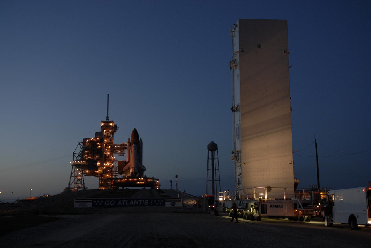 CAPE CANAVERAL, Fla. –– At NASA's Kennedy Space Center in Florida, the payload canister(right) with the Hubble Space Telescope equipment arrives at the base of Launch Pad 39A. On the pad, the Hubble equipment will be transferred to space shuttle Atlantis' payload bay. Atlantis' 11-day STS-125 mission to service Hubble is targeted for launch May 12. The flight will include five spacewalks in which astronauts will refurbish and upgrade the telescope with state-of-the-art science instruments. As a result, Hubble's capabilities will be expanded and its operational lifespan extended through at least 2014. Photo credit: NASA/Kim Shiflett
