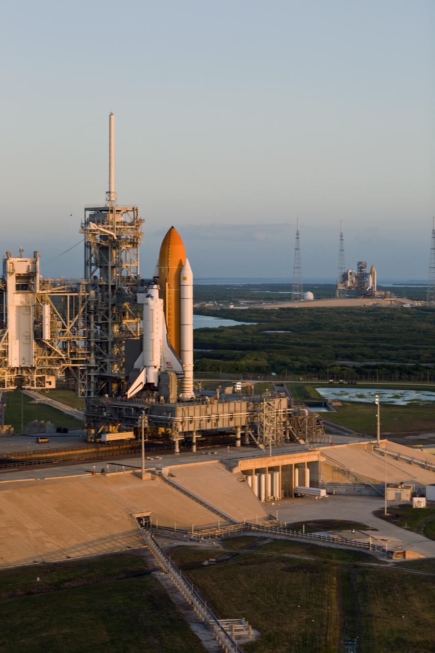 CAPE CANAVERAL, Fla. –– Space shuttle Atlantis (left) and space shuttle Endeavour are seen on Launch Pads 39A and 39B, respectively, at NASA's Kennedy Space Center in Florida. This is probably the final time two shuttles will be on launch pads at the same time with the space shuttle fleet set for retirement in 2010. Surrounding pad 39B are the lightning towers erected for NASA's Constellation Program, which will use the pad for Ares rocket launches. Endeavour will be prepared on the pad for liftoff in the unlikely event that a rescue mission is necessary following space shuttle Atlantis' launch on the STS-125 mission to service NASA's Hubble Space Telescope. After Atlantis is cleared to land, Endeavour will move to Launch Pad 39A for its upcoming STS-127 mission to the International Space Station, targeted to launch June 13. Photo credit: NASA/Dimitri Gerondidakis