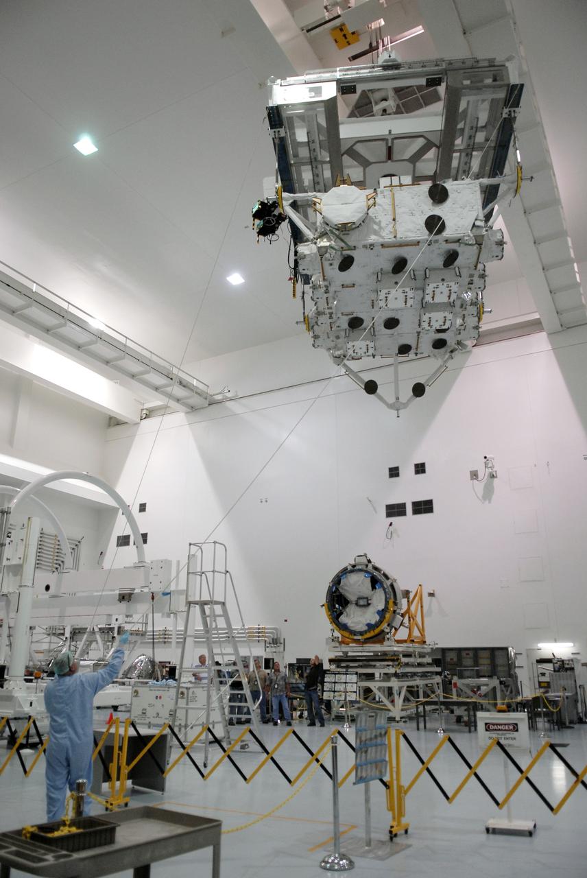 CAPE CANAVERAL, Fla. –– In the Space Station Processing Facility at NASA's Kennedy Space Center in Florida, the suspended Japan Aerospace Exploration Agency's Kibo Exposed Facility, or EF, is guided toward a workstand, at left. When it is installed on the Kibo laboratory, the EF will provide a multipurpose platform where science experiments can be deployed and operated in the exposed environment. The payloads attached to the EF can be exchanged or retrieved by Kibo's robotic arm, the JEM Remote Manipulator System. The EF, along with the Experiment Logistics Module Exposed Section, will be carried aboard space shuttle Endeavour on the STS-127 mission targeted for launch June 13, 2009. Photo credit: NASA/Kim Shiflett