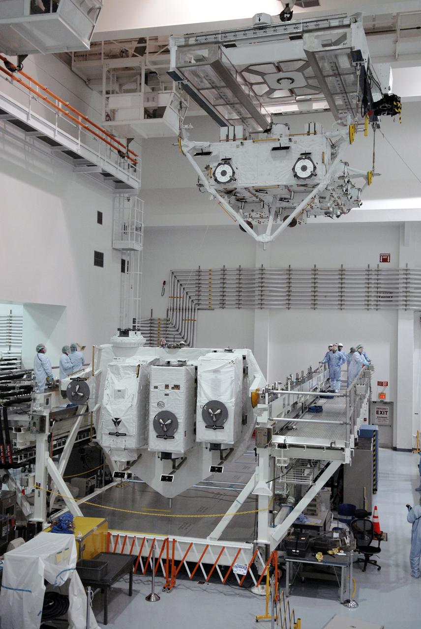 CAPE CANAVERAL, Fla. –– In the Space Station Processing Facility at NASA's Kennedy Space Center in Florida, the suspended Japan Aerospace Exploration Agency's Kibo Exposed Facility, or EF, is moved over a workstand. When it is installed on the Kibo laboratory, the EF will provide a multipurpose platform where science experiments can be deployed and operated in the exposed environment. The payloads attached to the EF can be exchanged or retrieved by Kibo's robotic arm, the JEM Remote Manipulator System. The EF, along with the Experiment Logistics Module Exposed Section, will be carried aboard space shuttle Endeavour on the STS-127 mission targeted for launch June 13, 2009. Photo credit: NASA/Kim Shiflett