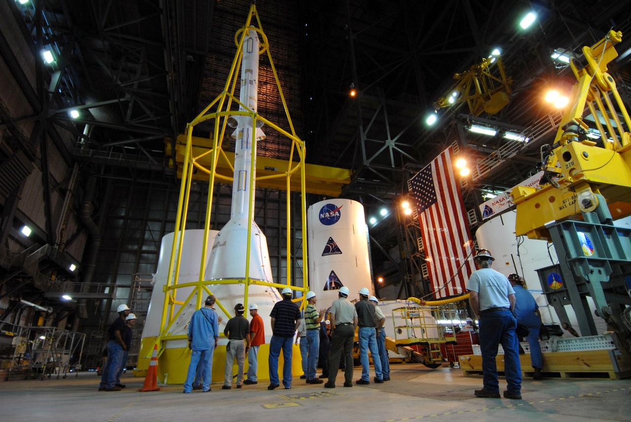CAPE CANAVERAL, Fla. –– In High Bay 4 of the Vehicle Assembly Building at NASA's Kennedy Space Center in Florida, the yellow framework , nicknamed the "birdcage," is lowered over the Crew Module, or CM, and Launch Abort System, or LAS, assembly for a fit check.  Ares I-X is the flight test for the Ares I. The I-X flight will provide NASA an early opportunity to test and prove hardware, facilities and ground operations associated with Ares I.  The launch of the 327-foot-tall, full-scale Ares I-X is targeted for July 2009.  Photo credit: NASA/Jack Pfaller