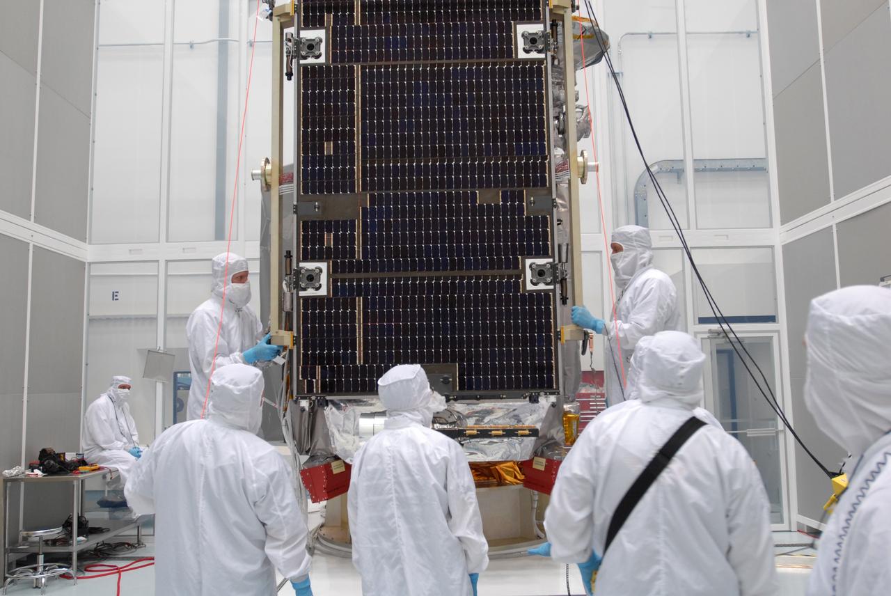 CAPE CANAVERAL, Fla. –– At Astrotech Space Operations in Titusville, Fla., technicians move the solar array panel closer to the Lunar Reconnaissance Orbiter, or LRO, for installation. The orbiter will carry seven instruments to provide scientists with detailed maps of the lunar surface and enhance our understanding of the moon's topography, lighting conditions, mineralogical composition and natural resources. Information gleaned from LRO will be used to select safe landing sites, determine locations for future lunar outposts and help mitigate radiation dangers to astronauts. The polar regions of the moon are the main focus of the mission because continuous access to sunlight may be possible and water ice may exist in permanently shadowed areas of the poles. Launch of LRO is targeted for June 2.  Photo credit: NASA/Jim Grossmann