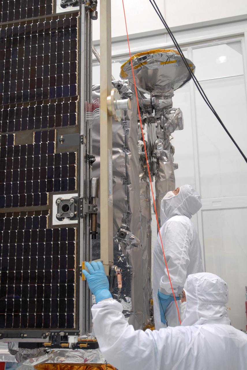 CAPE CANAVERAL, Fla. –– At Astrotech Space Operations in Titusville, Fla., technicians prepare to install the solar array panel to the Lunar Reconnaissance Orbiter, or LRO. The orbiter will carry seven instruments to provide scientists with detailed maps of the lunar surface and enhance our understanding of the moon's topography, lighting conditions, mineralogical composition and natural resources. Information gleaned from LRO will be used to select safe landing sites, determine locations for future lunar outposts and help mitigate radiation dangers to astronauts. The polar regions of the moon are the main focus of the mission because continuous access to sunlight may be possible and water ice may exist in permanently shadowed areas of the poles. Launch of LRO is targeted for June 2.  Photo credit: NASA/Jim Grossmann