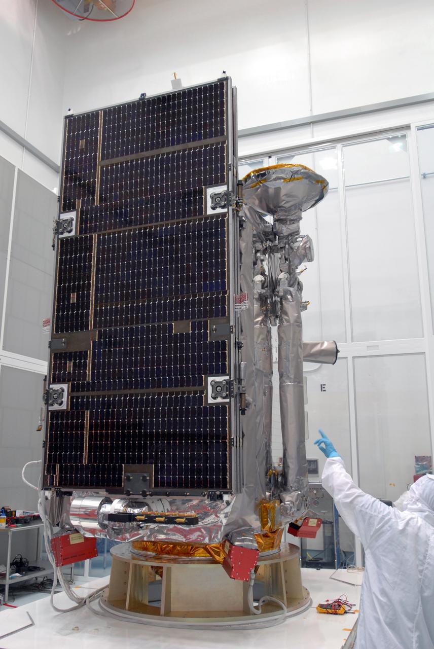 CAPE CANAVERAL, Fla. –– At Astrotech Space Operations in Titusville, Fla., a technician checks the installation of a solar array panel on the Lunar Reconnaissance Orbiter, or LRO. The orbiter will carry seven instruments to provide scientists with detailed maps of the lunar surface and enhance our understanding of the moon's topography, lighting conditions, mineralogical composition and natural resources. Information gleaned from LRO will be used to select safe landing sites, determine locations for future lunar outposts and help mitigate radiation dangers to astronauts. The polar regions of the moon are the main focus of the mission because continuous access to sunlight may be possible and water ice may exist in permanently shadowed areas of the poles. Launch of LRO is targeted for June 2.  Photo credit: NASA/Jim Grossmann