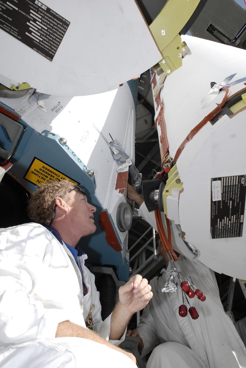 CAPE CANAVERAL, Fla. – On Launch Pad 17-B at Cape Canaveral Air Force Station, a worker attaches solid rocket boosters to a Delta II rocket for launch of the STSS Demonstrator spacecraft. The spacecraft is a midcourse tracking technology demonstrator, part of an evolving ballistic missile defense system. STSS is capable of tracking objects after boost phase and provides trajectory information to other sensors. It will be launched by NASA for the Missile Defense Agency on July 29. Photo credit: NASA/Kim Shiflett