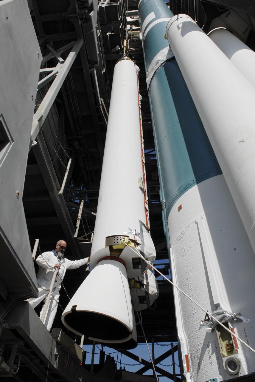 CAPE CANAVERAL, Fla. – On Launch Pad 17-B at Cape Canaveral Air Force Station, a worker monitors the placement of a solid rocket booster on a Delta II rocket for launch of the STSS Demonstrator spacecraft. The spacecraft is a midcourse tracking technology demonstrator, part of an evolving ballistic missile defense system. STSS is capable of tracking objects after boost phase and provides trajectory information to other sensors. It will be launched by NASA for the Missile Defense Agency on July 29. Photo credit: NASA/Kim Shiflett