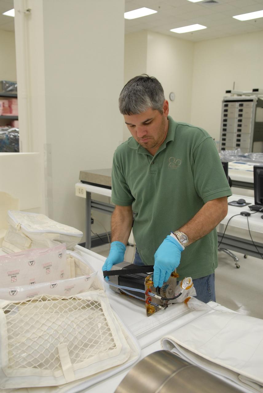 CAPE CANAVERAL, Fla. –– In the Space Station Processing Facility at NASA's Kennedy Space Center in Florida, a worker prepares to pack a component of the Combined Operational Load Bearing External Resistance Treadmill, or COLBERT, for launch to the International Space Station on the space shuttle Discovery STS-128 mission.  The treadmill is named after comedian Stephen Colbert, the host of Comedy Central’s “The Colbert Report.” Colbert urged his viewers to suggest the name “Colbert” as the name for the station’s Node 3 module. Although his name did receive the most entries in an Internet polling contest, NASA chose the name “Tranquility” to honor the accomplishments of the Apollo 11 mission. COLBERT will be installed in Tranquility after the node arrives at the station next year. Launch of STS-128 is targeted for Aug. 6, 2009. Photo credit: NASA/Jack Pfaller