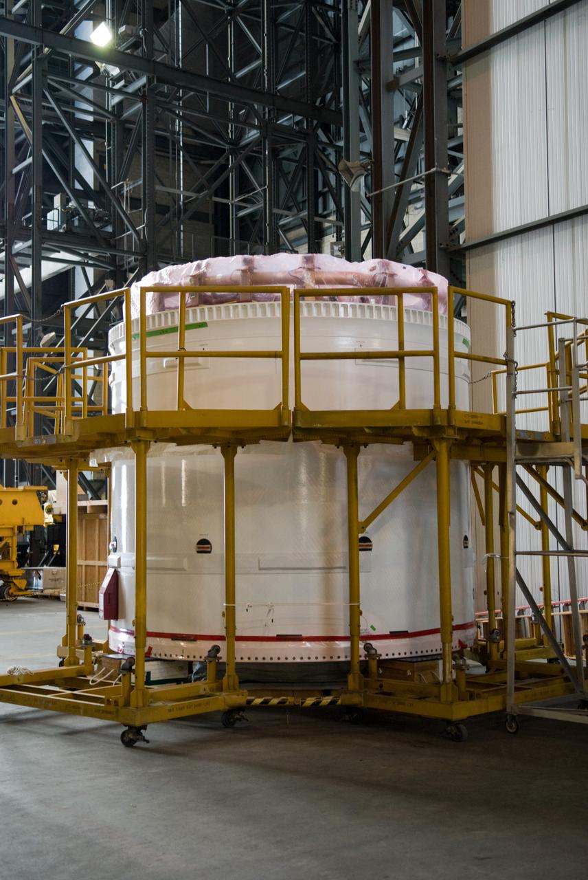 CAPE CANAVERAL, Fla. –– The fifth segment simulator segments of the Ares I-X rocket have been moved to the transfer aisle of the Vehicle Assembly Building at NASA's Kennedy Space Center in Florida.  The stacking operations with other segments in the VAB in June.  Ares I-X is the flight test for the Ares I. The I-X flight will provide NASA an early opportunity to test and prove hardware, facilities and ground operations associated with Ares I, which is part of the Constellation Program to return men to the moon and beyond. Launch of the Ares I-X flight test is targeted for August 2009.   Photo credit: NASA/Jack Pfaller
