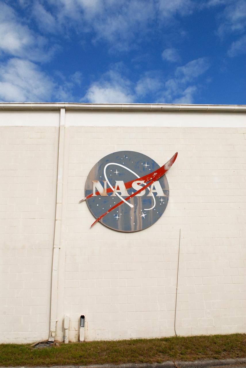 CAPE CANAVERAL, Fla. – The NASA insignia has faded on the 50-year-old Mission Control Center on the Cape Canaveral Air Force Station in Florida. Out of use for many years, and with no valid operational or other use for the facility, NASA plans to demolish the site. The facility once controlled all manned Mercury space flights and the first two unmanned Gemini flights from May 1961-1963. It provided launch, orbital, re-entry and landing control for the flights. That function was later transferred to NASA's Johnson Space Center in Houston. Photo credit: NASA/Jack Pfaller
