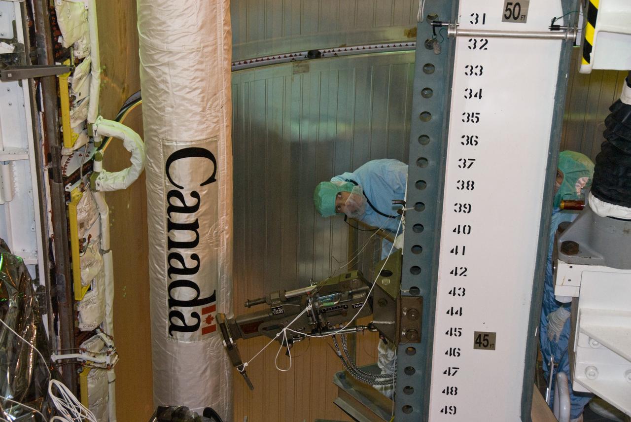 CAPE CANAVERAL, Fla. –– In space shuttle Atlantis' payload bay at NASA Kennedy Space Center's Launch Pad 39A, STS-125 Mission Specialist Megan McArthur takes a final close look at the hardware for the Hubble servicing mission before the targeted May 11 launch. Atlantis' 11-day mission will include five spacewalks to refurbish and upgrade the telescope with state-of-the-art science instruments. The payload bay holds four carriers of equipment that include the Wide Field Camera 3, Cosmic Origins Spectrograph, the Soft Capture Mechanism and replacement gyroscopes and batteries. As a result, Hubble's capabilities will be expanded and its operational lifespan extended through at least 2014. Photo credit: NASA/Kim Shiflett