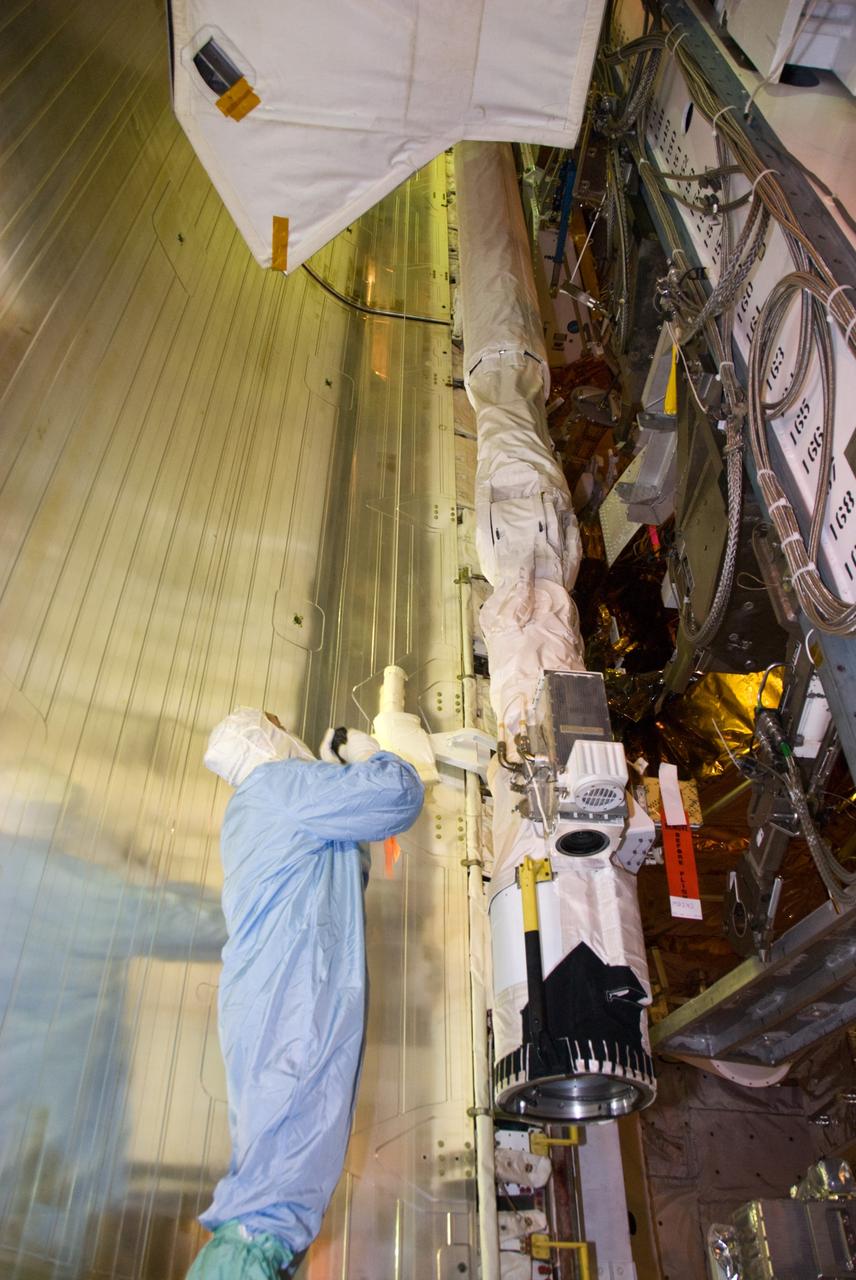 CAPE CANAVERAL, Fla. –– In space shuttle Atlantis' payload bay at NASA Kennedy Space Center's Launch Pad 39A, STS-125 crew members take a final close look at the hardware for the Hubble servicing mission before the targeted May 11 launch. Atlantis' 11-day mission will include five spacewalks to refurbish and upgrade the telescope with state-of-the-art science instruments. The payload bay holds four carriers of equipment that include the Wide Field Camera 3, Cosmic Origins Spectrograph, the Soft Capture Mechanism and replacement gyroscopes and batteries. As a result, Hubble's capabilities will be expanded and its operational lifespan extended through at least 2014. Photo credit: NASA/Kim Shiflett