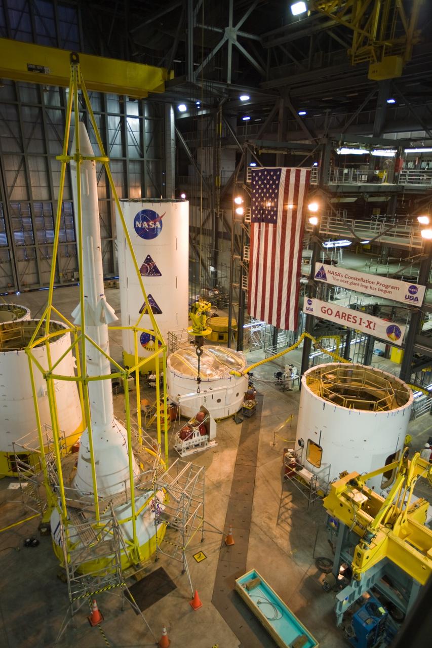 CAPE CANAVERAL, Fla. –– In High Bay 4 of the Vehicle Assembly Building at NASA's Kennedy Space Center in Florida, various segments of the Ares I-X are placed around the floor. In the center is a second roll control system module that will be installed in one of the segments. At left is the yellow metal framework, called the "birdcage," surrounding the simulator launch abort system and crew module. Ares I-X is the test vehicle for the Ares I, which is part of the Constellation Program to return men to the moon and beyond. Ares I-X is targeted for launch in August 2009. Photo credit: NASA/Dimitri Gerondidakis