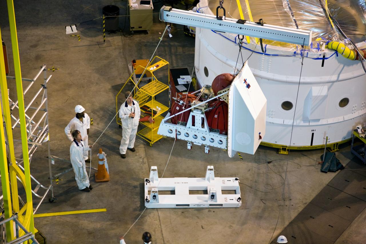 CAPE CANAVERAL, Fla. –– In High Bay 4 of the Vehicle Assembly Building at NASA's Kennedy Space Center in Florida, a crane lifts a second roll control system module for installation in an Ares I-X segment. Ares I-X is the test vehicle for the Ares I, which is part of the Constellation Program to return men to the moon and beyond. Ares I-X is targeted for launch in August 2009.  Photo credit: NASA/Dimitri Gerondidakis