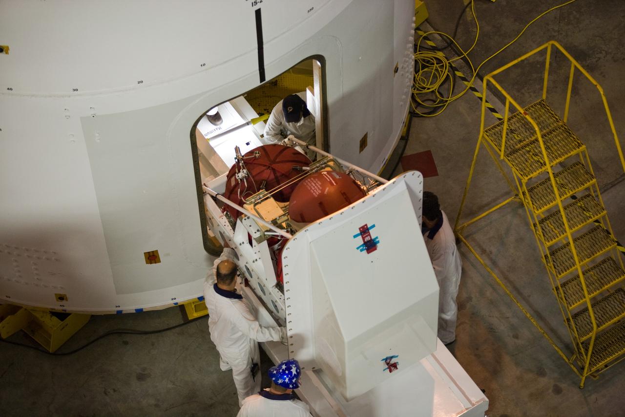 CAPE CANAVERAL, Fla. –– In High Bay 4 of the Vehicle Assembly Building at NASA's Kennedy Space Center in Florida, technicians maneuver a second roll control system module into place for installation in the Ares I-X segment. Ares I-X is the test vehicle for the Ares I, which is part of the Constellation Program to return men to the moon and beyond. Ares I-X is targeted for launch in August 2009. Photo credit: NASA/Dimitri Gerondidakis