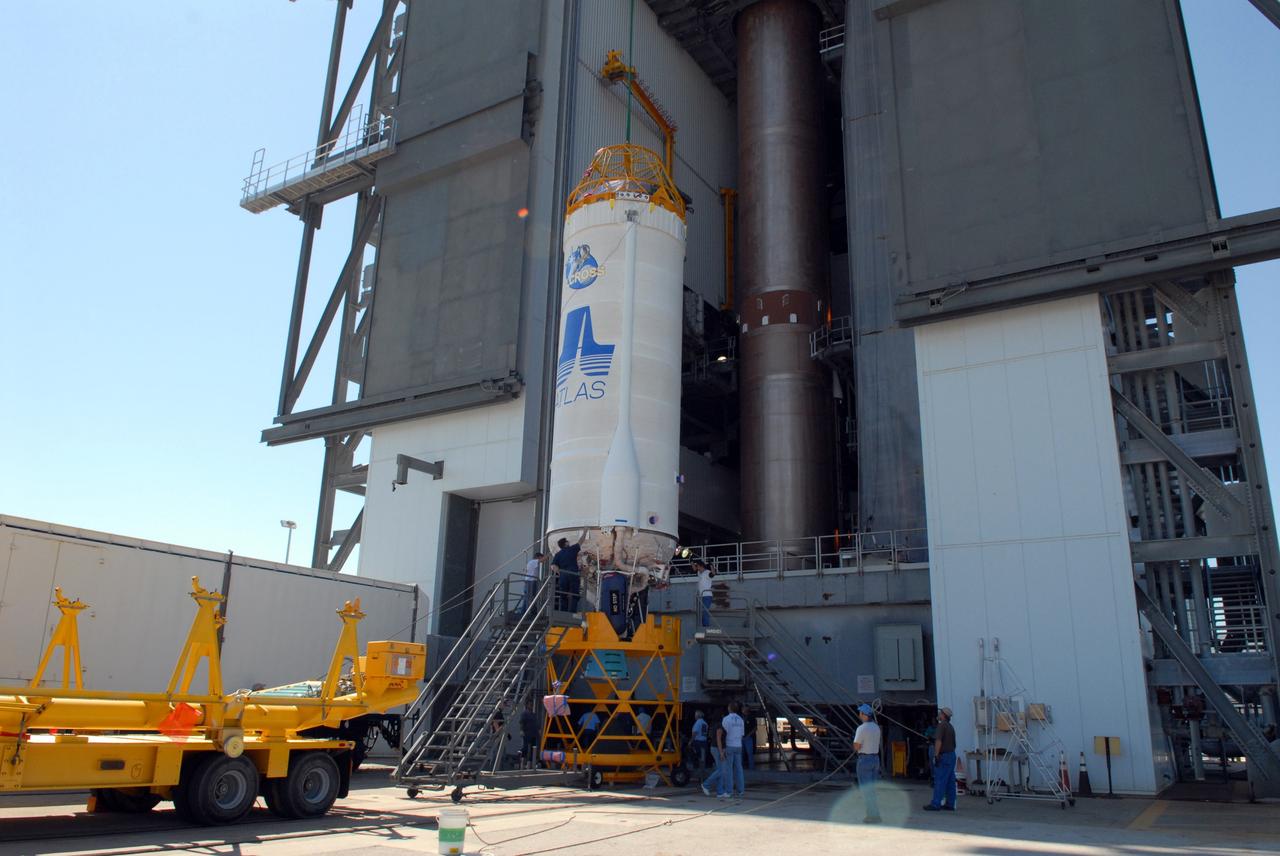 CAPE CANAVERAL, Fla. –– On Cape Canaveral Air Force Station's Launch Complex 41, the crane begins lifting the Centaur upper stage into the Vertical Integration Facility for installation onto the Atlas V first stage, already in the tower. The Atlas V/Centaur is the launch vehicle for NASA's Lunar Reconnaissance Orbiter, or LRO, and NASA's Lunar CRater Observation and Sensing Satellite, known as LCROSS.  LCROSS and LRO are the first missions in NASA's plan to return humans to the moon and begin establishing a lunar outpost by 2020.  Photo credit: NASA/Jack Pfaller