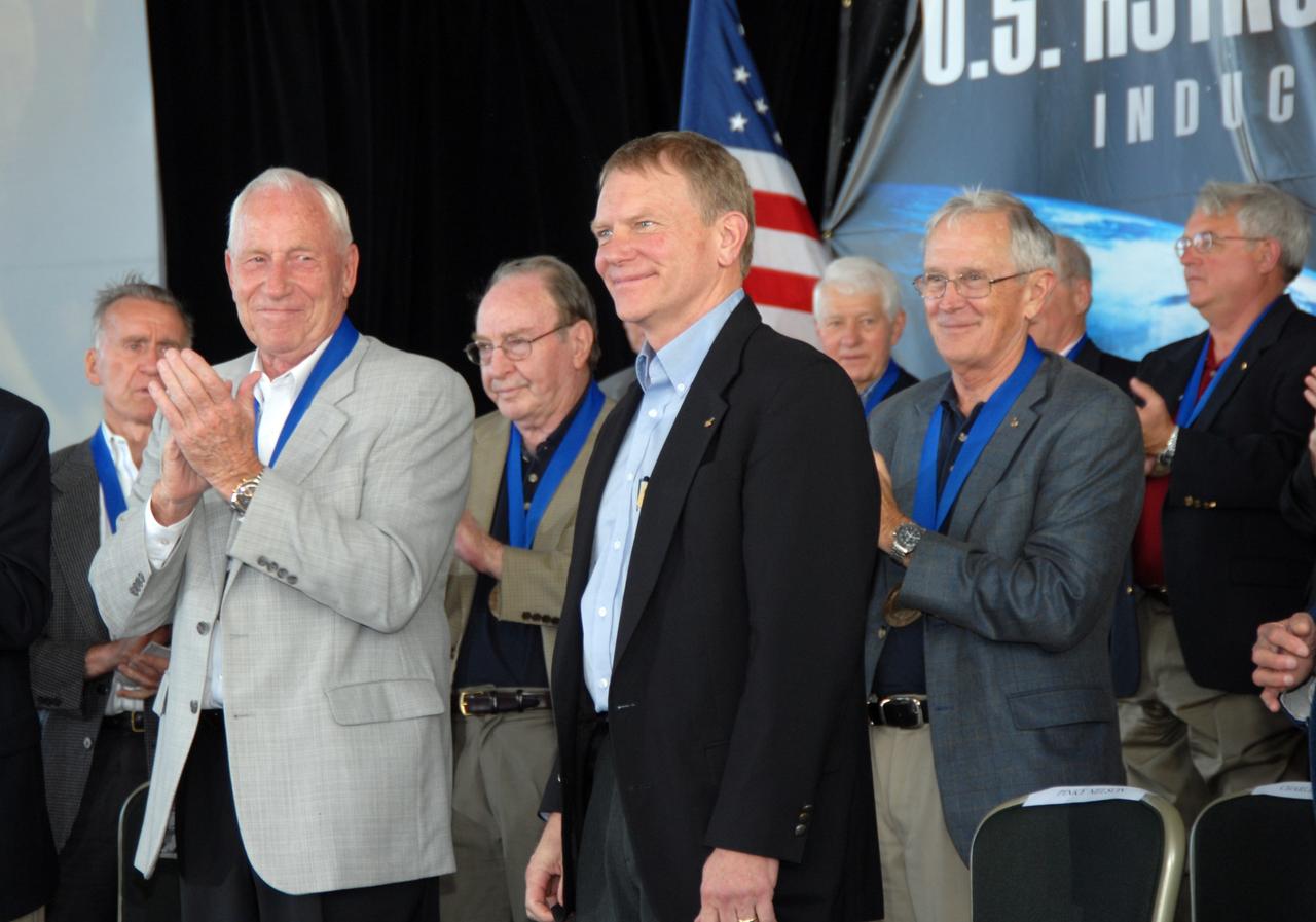 CAPE CANAVERAL, Fla. –– George "Pinky" Nelson (right) is introduced as one of the new members of the U.S. Astronaut Hall of Fame at NASA's Kennedy Space Center Visitor Complex in Florida. At left is hall of fame member Al Worden.  Nelson was one of only four space shuttle astronauts to fly untethered in space using NASA's Manned Maneuvering Unit. The ceremony took place May 2. More than 20 hall of fame astronauts attended, including Scott Carpenter, Walt Cunningham, Jim Lovell and Bob Crippen. Photo credit: NASA/Jim Grossmann
