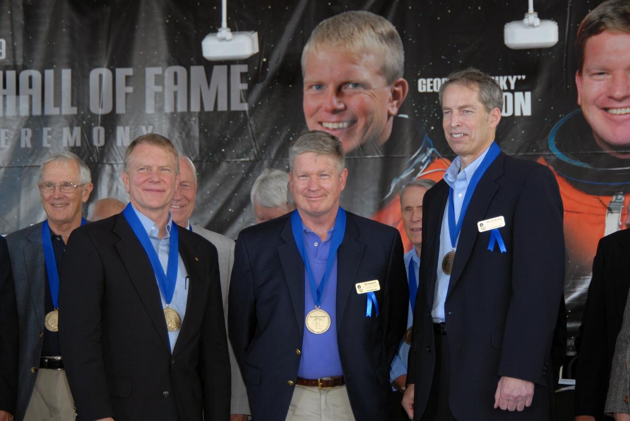 CAPE CANAVERAL, Fla. –– The three newest inductees into the U.S. Astronaut Hall of Fame proudly join current members after the induction ceremony held at NASA's Kennedy Space Center Visitor Complex in Florida.  In front, from left, are George "Pinky" Nelson, who was one of only six space shuttle astronauts to fly untethered in space using NASA's Manned Maneuvering Unit; William Shepherd, who was commander of the first crew to live aboard the International Space Station; and James Wetherbee, who was commander of the longest-docked shuttle-Mir mission. The ceremony was held at NASA's Kennedy Space Center Visitor Complex in Florida. The ceremony took place May 2. More than 20 hall of fame astronauts attended, including Scott Carpenter, Walt Cunningham, Jim Lovell and Bob Crippen. Photo credit: NASA/Jim Grossmann