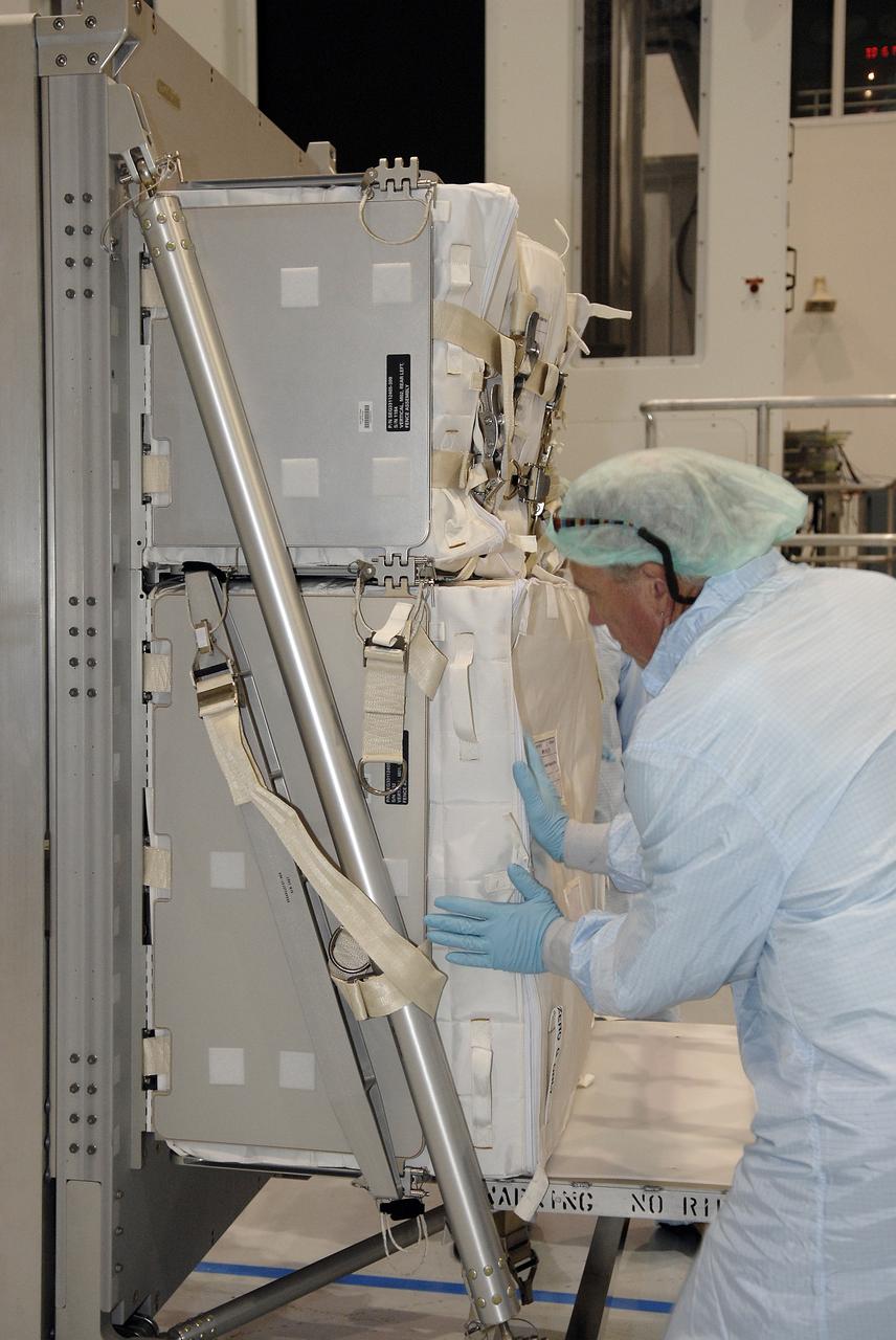 CAPE CANAVERAL, Fla. – In the Space Station Processing Facility at NASA's Kennedy Space Center in Florida, technicians place equipment in the Resupply Stowage Platform, or RSP, to be installed in the multi-purpose logistics module Leonardo. The module is part of the payload for space shuttle Discovery's STS-128 mission. Discovery will carry science and storage racks to the International Space Station . Launch of Discovery is targeted for Aug. 6.  Photo credit: NASA/Kim Shiflett