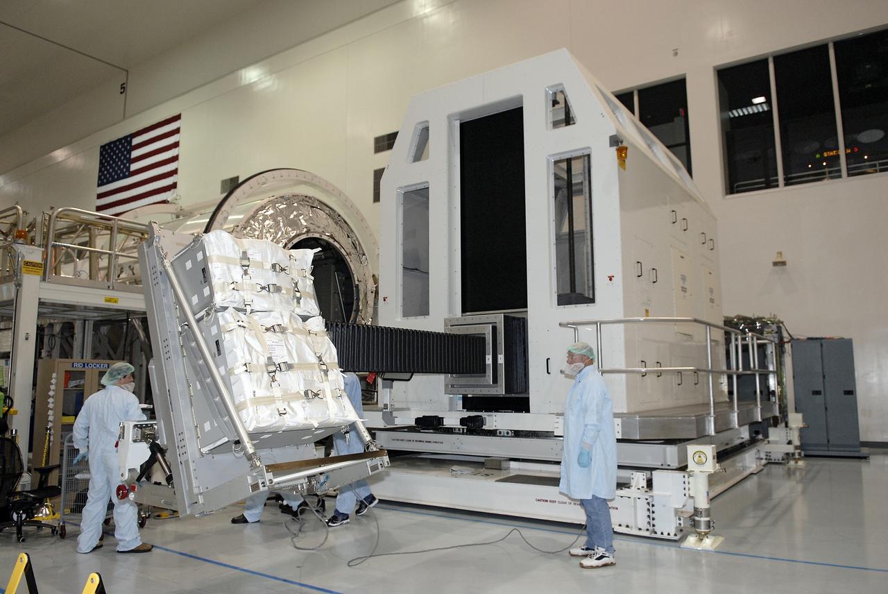 CAPE CANAVERAL, Fla. – In the Space Station Processing Facility at NASA's Kennedy Space Center in Florida, the rack insertion device lifts the Resupply Stowage Platform, or RSP, for installation in the multi-purpose logistics module Leonardo. The module is part of the payload for space shuttle Discovery's STS-128 mission. Discovery will carry science and storage racks to the International Space Station . Launch of Discovery is targeted for Aug. 6.  Photo credit: NASA/Kim Shiflett