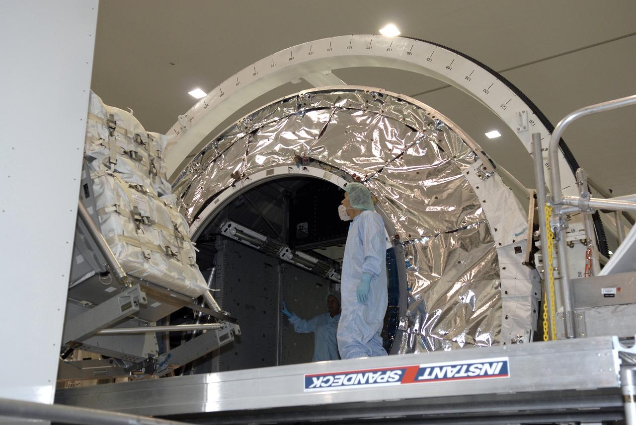 CAPE CANAVERAL, Fla. – In the Space Station Processing Facility at NASA's Kennedy Space Center in Florida, the rack insertion device moves the Resupply Stowage Platform, or RSP, toward the opening in the multi-purpose logistics module Leonardo. The module is part of the payload for space shuttle Discovery's STS-128 mission.  Discovery will carry science and storage racks to the International Space Station . Launch of Discovery is targeted for Aug. 6.  Photo credit: NASA/Kim Shiflett