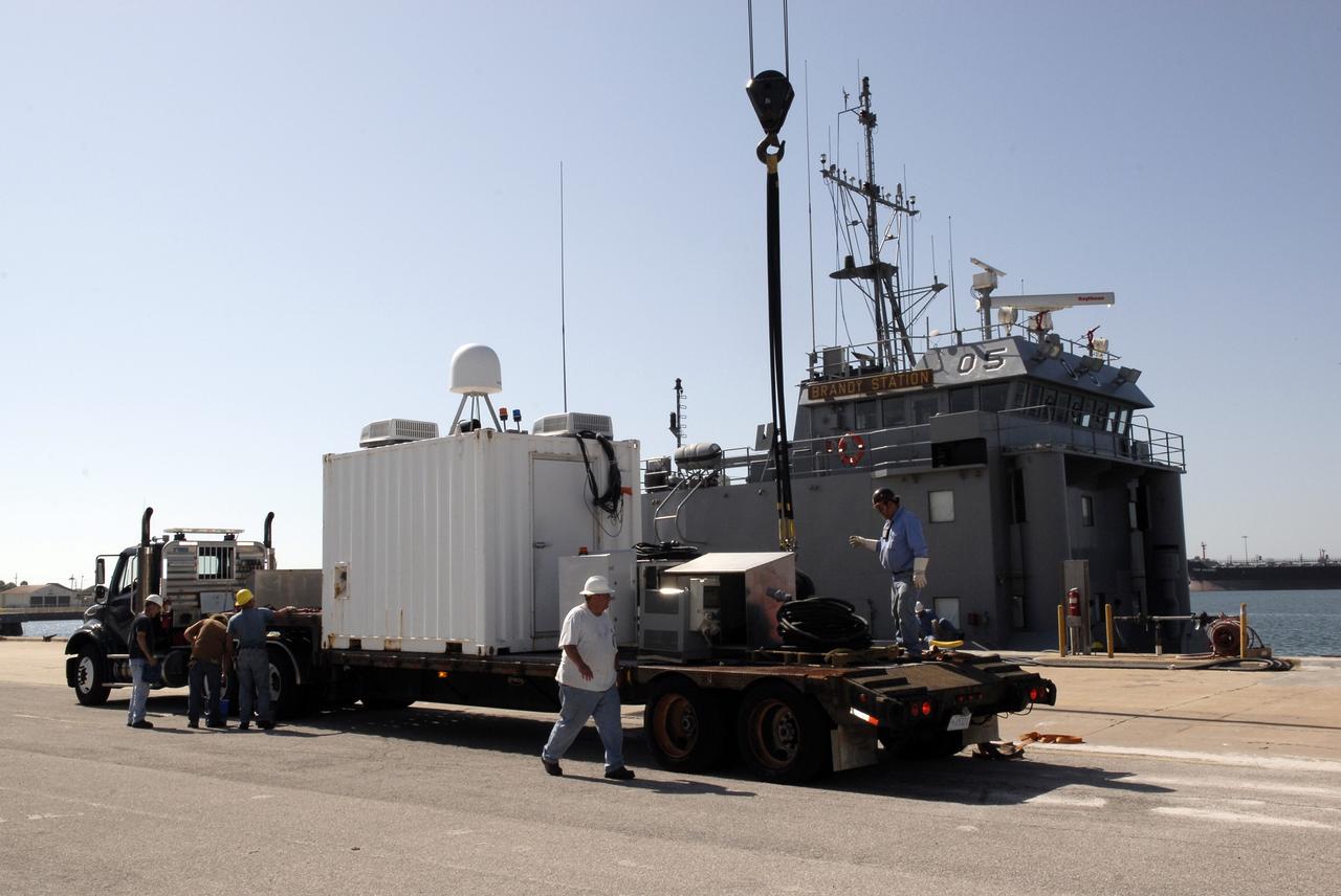 CAPE CANAVERAL, Fla. – In Port Canaveral, Fla.,  a container is prepared for transfer to the U.S. Army landing craft utility ship Brandy Station. Inside is the control center for the X-band radar installed on the deck of the ship.  The radar will provide critical support during launch of space shuttle Atlantis on the STS-125 mission.  The radar will work with smaller X-band radars placed on the solid rocket booster retrieval ship Liberty Star to provide extremely high-resolution images of any debris that might be created during Atlantis' launch.  Photo credit: NASA/Kim Shiflett