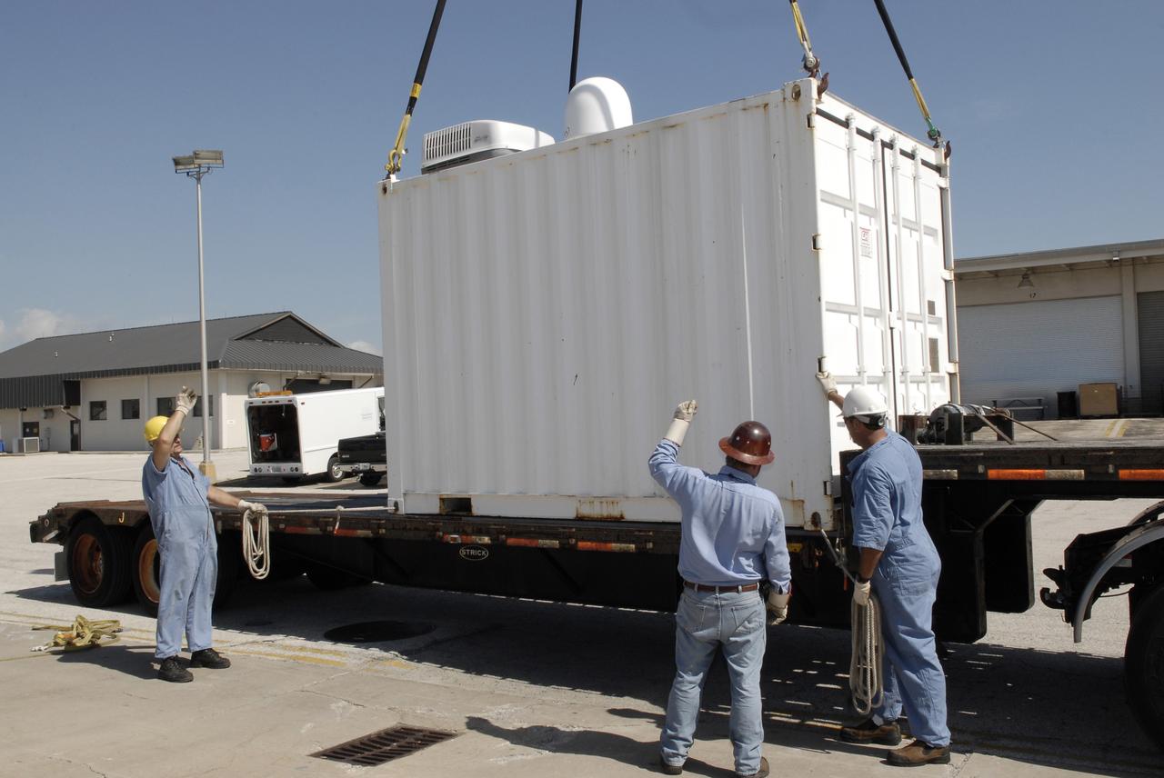 CAPE CANAVERAL, Fla. – In Port Canaveral, Fla.,  a container is lifted from the transporter for transfer to the U.S. Army landing craft utility ship Brandy Station. Inside is the control center for the X-band radar installed on the deck of the ship.  The radar will provide critical support during launch of space shuttle Atlantis on the STS-125 mission.  The radar will work with smaller X-band radars placed on the solid rocket booster retrieval ship Liberty Star to provide extremely high-resolution images of any debris that might be created during Atlantis' launch.  Photo credit: NASA/Kim Shiflett