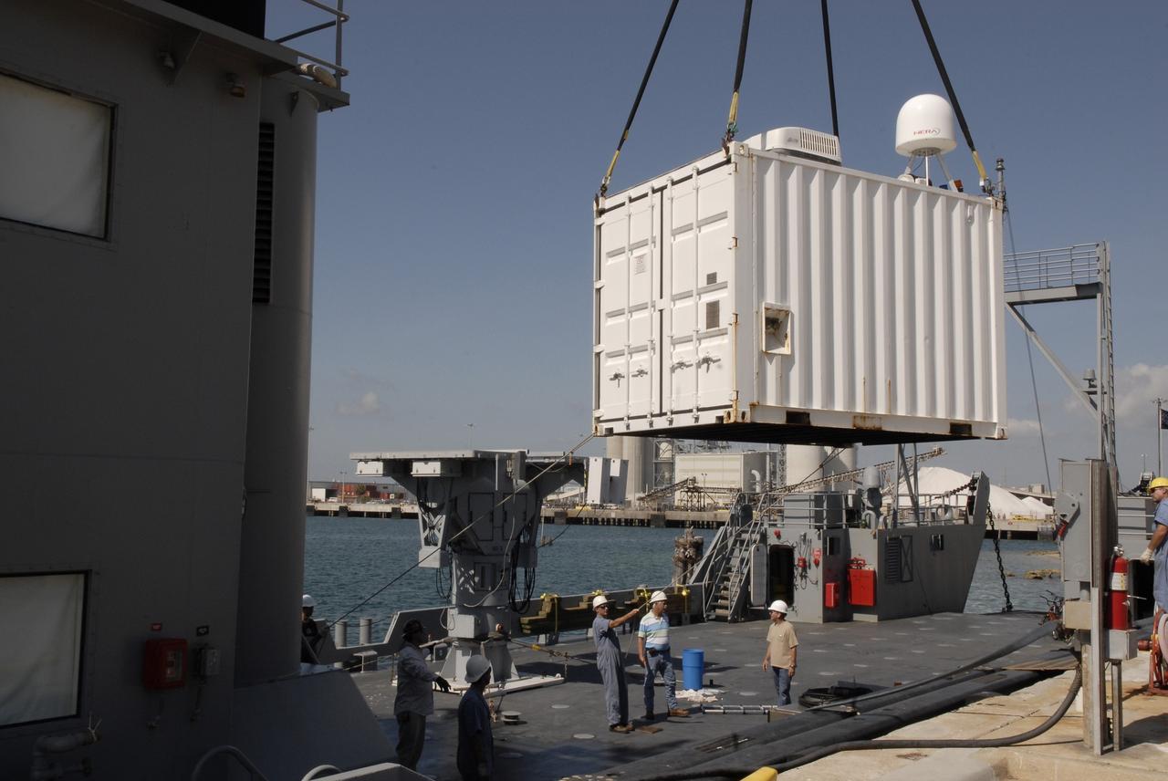 CAPE CANAVERAL, Fla. – In Port Canaveral, Fla.,  a crane moves a container toward the deck of the U.S. Army landing craft utility ship Brandy Station. Inside is the control center for the X-band radar installed on the deck of the ship.  The radar will provide critical support during launch of space shuttle Atlantis on the STS-125 mission.  The radar will work with smaller X-band radars placed on the solid rocket booster retrieval ship Liberty Star to provide extremely high-resolution images of any debris that might be created during Atlantis' launch.  Photo credit: NASA/Kim Shiflett