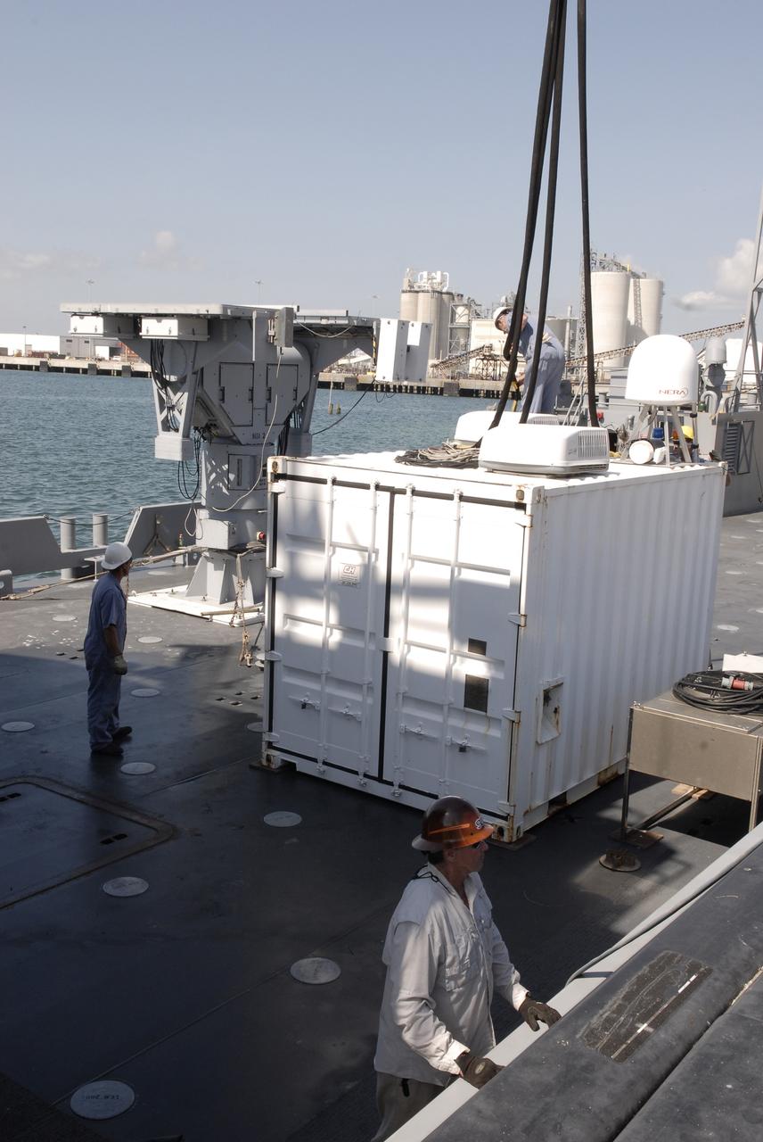 CAPE CANAVERAL, Fla. – In Port Canaveral, Fla.,  a crane lowers a container toward the deck of the U.S. Army landing craft utility ship Brandy Station. Inside is the control center for the X-band radar installed on the deck of the ship.  The radar will provide critical support during launch of space shuttle Atlantis on the STS-125 mission.  The radar will work with smaller X-band radars placed on the solid rocket booster retrieval ship Liberty Star to provide extremely high-resolution images of any debris that might be created during Atlantis' launch.  Photo credit: NASA/Kim Shiflett