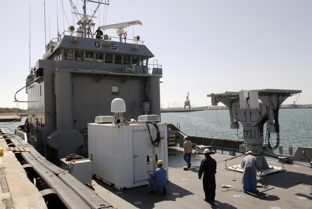 CAPE CANAVERAL, Fla. – In Port Canaveral, Fla.,  workers prepare the container that holds the control center for the X-band radar, at right, installed on the U.S. Army landing craft utility ship Brandy Station. The radar will provide critical support during launch of space shuttle Atlantis on the STS-125 mission.  The radar will work with smaller X-band radars placed on the solid rocket booster retrieval ship Liberty Star to provide extremely high-resolution images of any debris that might be created during Atlantis' launch.  Photo credit: NASA/Kim Shiflett