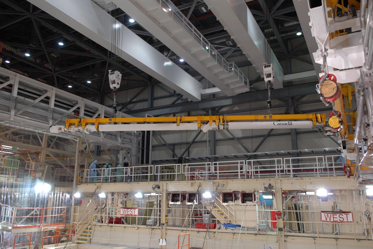 CAPE CANAVERAL, Fla. –  In Orbiter Processing Facility bay 3 at NASA's Kennedy Space Center in Florida, the remote manipulator system, or RMS, arm is lifted away from space shuttle Discovery's payload bay. The RMS is used to grab, or grapple, the payload as well as retrieve, repair and deploy satellites; provide a mobile extension ladder for spacewalking crewmembers; and be used as an inspection aid to allow flight crew members to view the orbiter’s or payload’s surfaces through a TV camera on the arm.  Discovery is targeted to launch Aug. 6 on the STS-128 mission.  Photo credit: NASA/Jack Pfaller