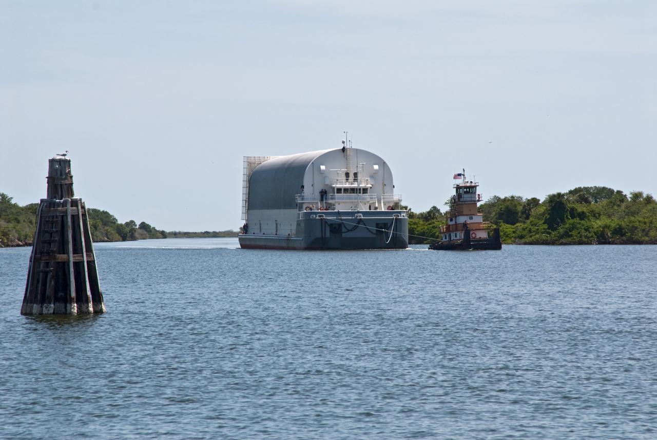 CAPE CANAVERAL, Fla. – The Pegasus barge, towed by a tugboat, enters the turn basin in the Launch Complex 39 Area at NASA's Kennedy Space Center in Florida.  The barge holds the external fuel tank, ET- 132, designated for space shuttle Discovery on the STS-128 mission.  The tank will be offloaded and transported to a high bay in the Vehicle Assembly Building for checkout. On the STS-128 mission, Discovery will carry science and storage racks to the International Space Station. Launch of Discovery is targeted for Aug. 6.  Photo credit: NASA/Troy Cryder