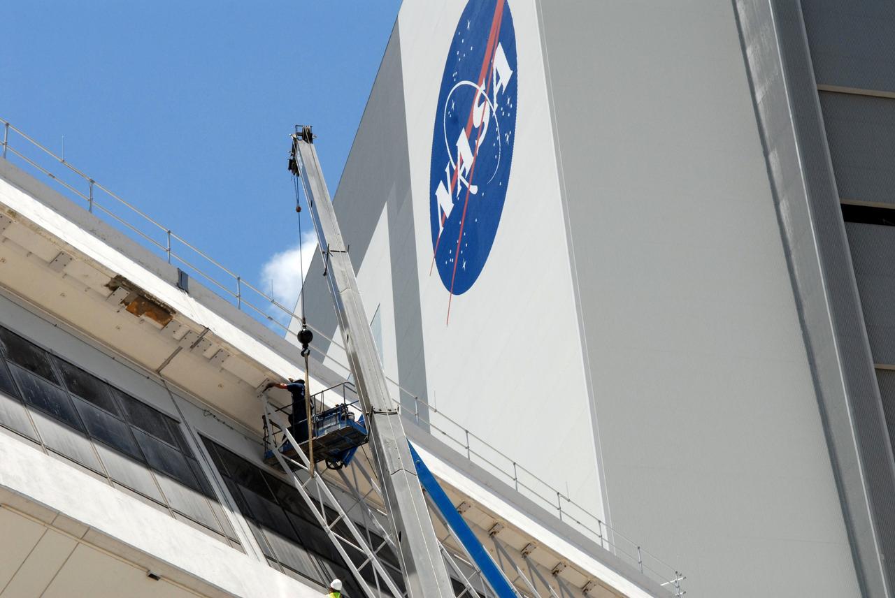 CAPE CANAVERAL, Fla. – A technician works at installing a new window in the Launch Control Center's Firing Room 1 at NASA's Kennedy Space Center in Florida. The firing room will support the future Ares rocket launches as part of NASA's Constellation Program. Future astronauts will ride to orbit on Ares I, launched from Kennedy's Launch Pad 39B. The Launch Control Center firing rooms face the launch pads. Photo credit: NASA/Jack Pfaller