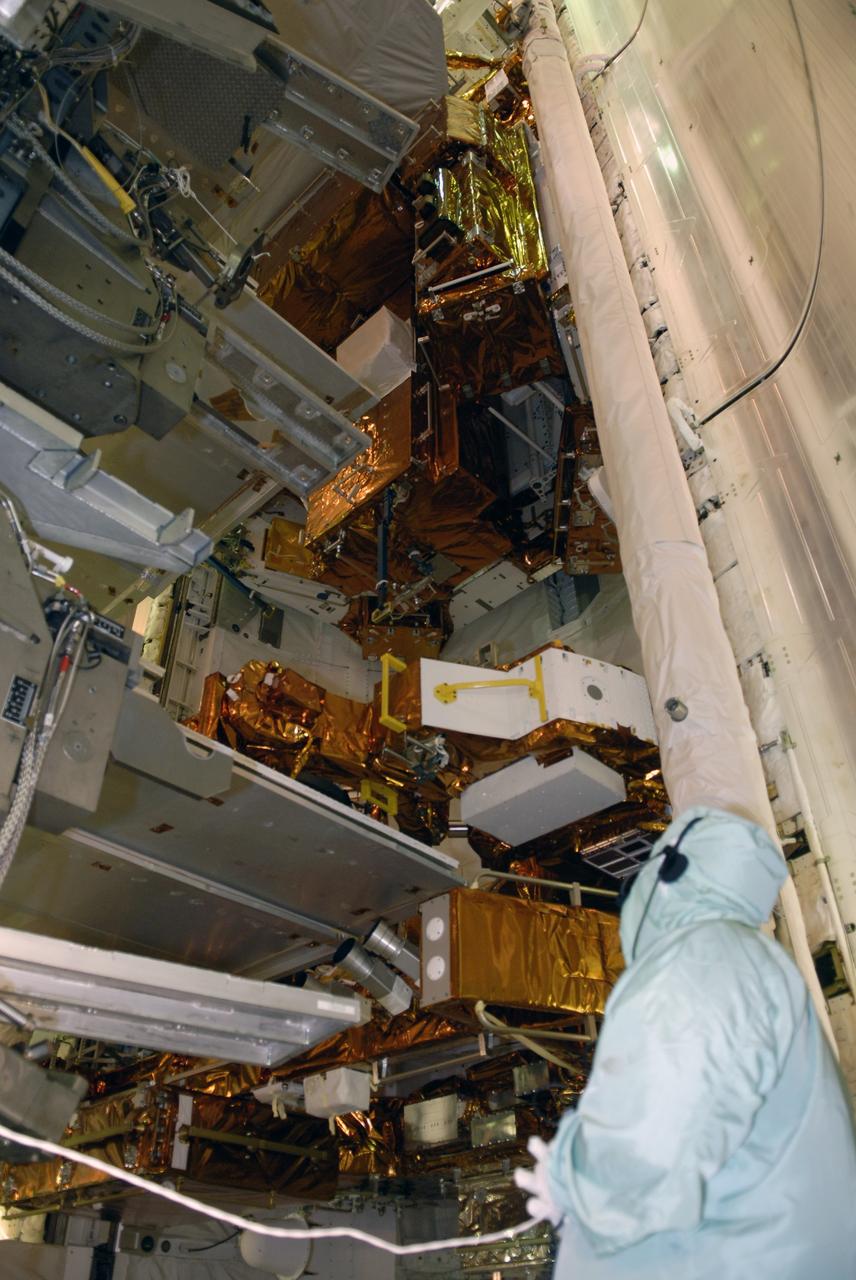 CAPE CANAVERAL, Fla. – On Launch Pad 39A at NASA's Kennedy Space Center in Florida, the payload ground-handling mechanism, known as the PGHM, is retracted after installing the payloads in space shuttle Atlantis' payload bay for the STS-125 mission.  Seen here are the service platforms of the PGHM.  The payload includes the Flight Support System, or FSS, carrier with the Soft Capture Mechanism; the Multi-Use Lightweight Equipment, or MULE, carrier with the Science Instrument Command and Data Handling Unit, or SIC&DH; the Orbital Replacement Unit Carrier, or ORUC, with the Cosmic Origins Spectrograph, or COS, and an IMAX 3D camera.  Atlantis' crew will service NASA's Hubble Space Telescope for the fifth and final time. The flight will include five spacewalks during which astronauts will refurbish and upgrade the telescope with state-of-the-art science instruments. As a result, Hubble's capabilities will be expanded and its operational lifespan extended through at least 2014.   Photo credit: NASA/Kim Shiflett