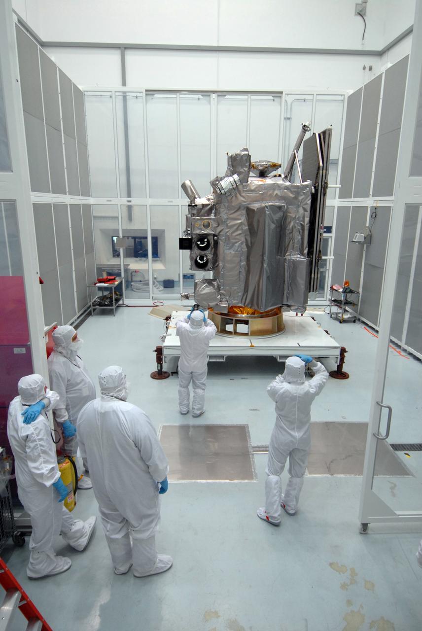 CAPE CANAVERAL, Fla. – At Astrotech Space Operations in Titusville, Fla.,  technicians photograph the Lunar Reconnaissance Orbiter, or LRO, during closeout before its mating with NASA's Lunar CRater Observation and Sensing Satellite, known as LCROSS, spacecraft. Instruments on the LRO include the LEND that will measure the flux of neutrons from the moon; the LROC, a narrow angle camera that will provide panchromatic images; the LOLA, which will provide a precise global lunar topographic model and geodetic grid; and top right, the DIVINER, which will measure lunar surface temperatures at scales that provide essential information for future surface operations and exploration; and at top, the CRaTER, which will characterize the global lunar radiation environment and its biological impacts. At right is the solar panel. The satellite's primary mission is to search for water ice on the moon in a permanently shadowed crater near one of the lunar poles. LCROSS is a low-cost, accelerated-development, companion mission to NASA's Lunar Reconnaissance Orbiter, or LRO. LCROSS and LRO are the first missions in NASA's plan to return humans to the moon and begin establishing a lunar outpost by 2020. Launch is targeted for no earlier than June 2 from Cape Canaveral Air Force Station in Florida. Photo credit: NASA/Jack Pfaller